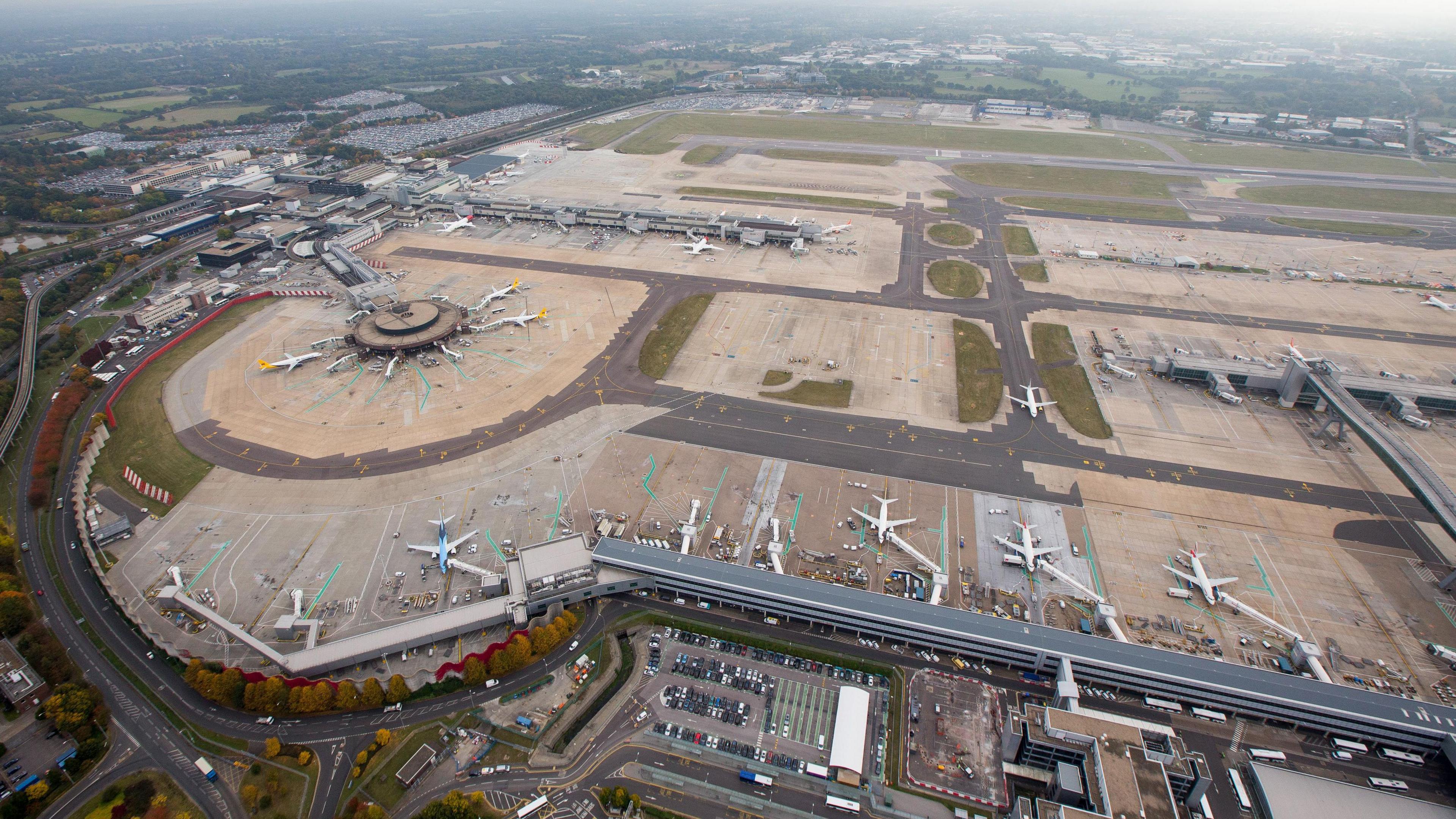 An aerial view over Gatwick Airport and its runways.