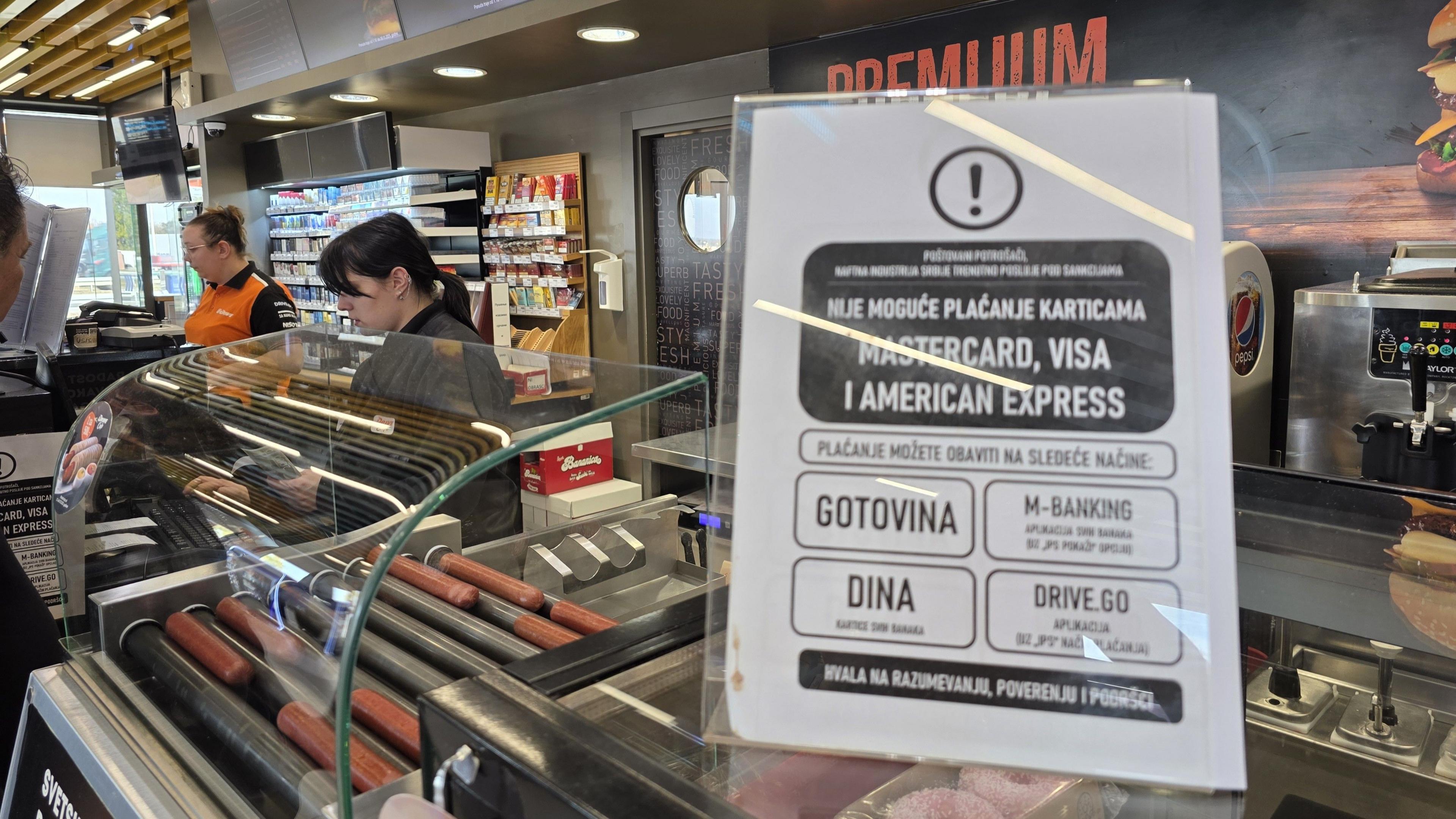 A sign in a petrol station says no credit cards are allowed for petrol purchases