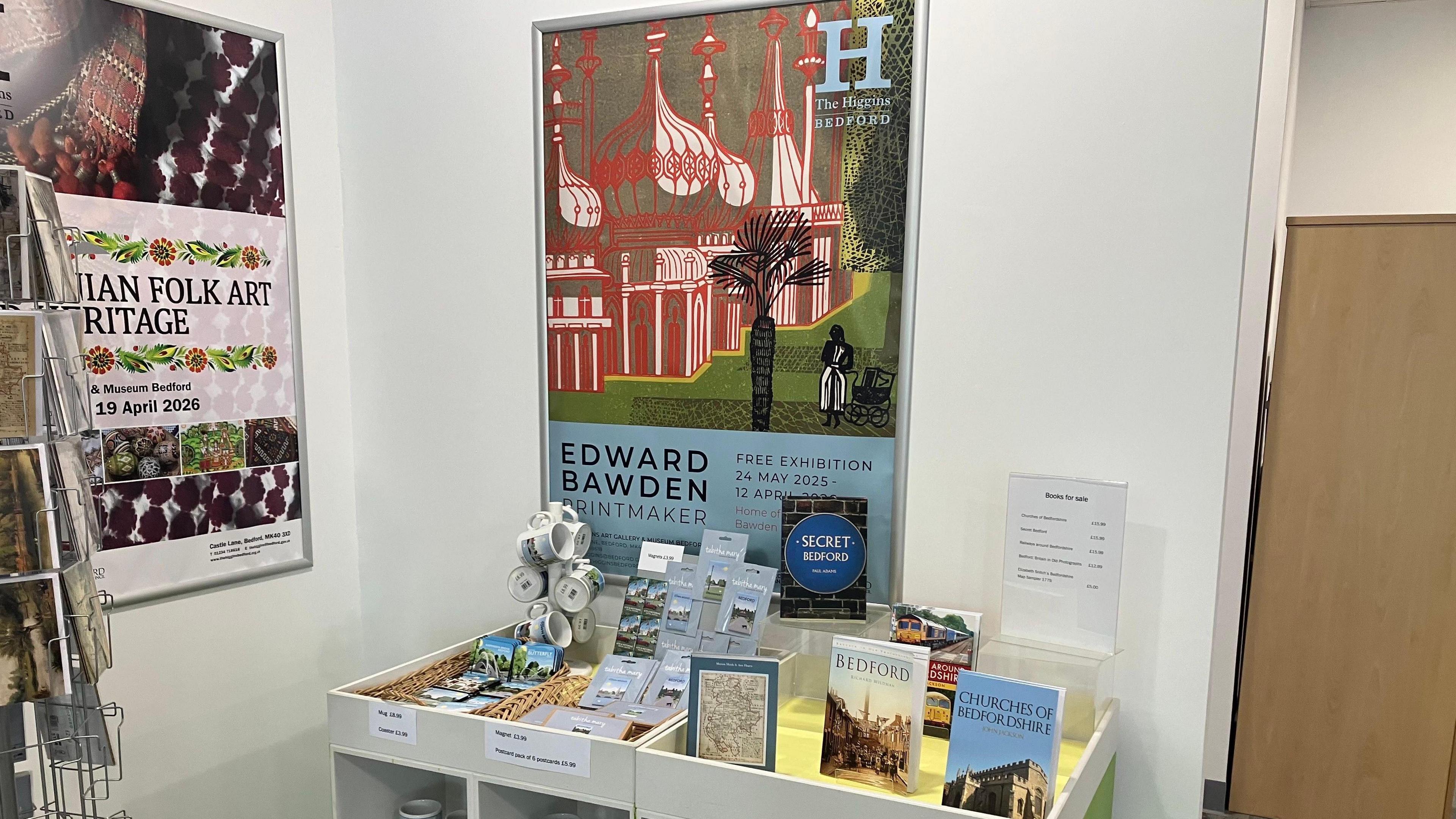 A picture of various books and mugs and souvenirs inside the Bedford cultural hub on display.