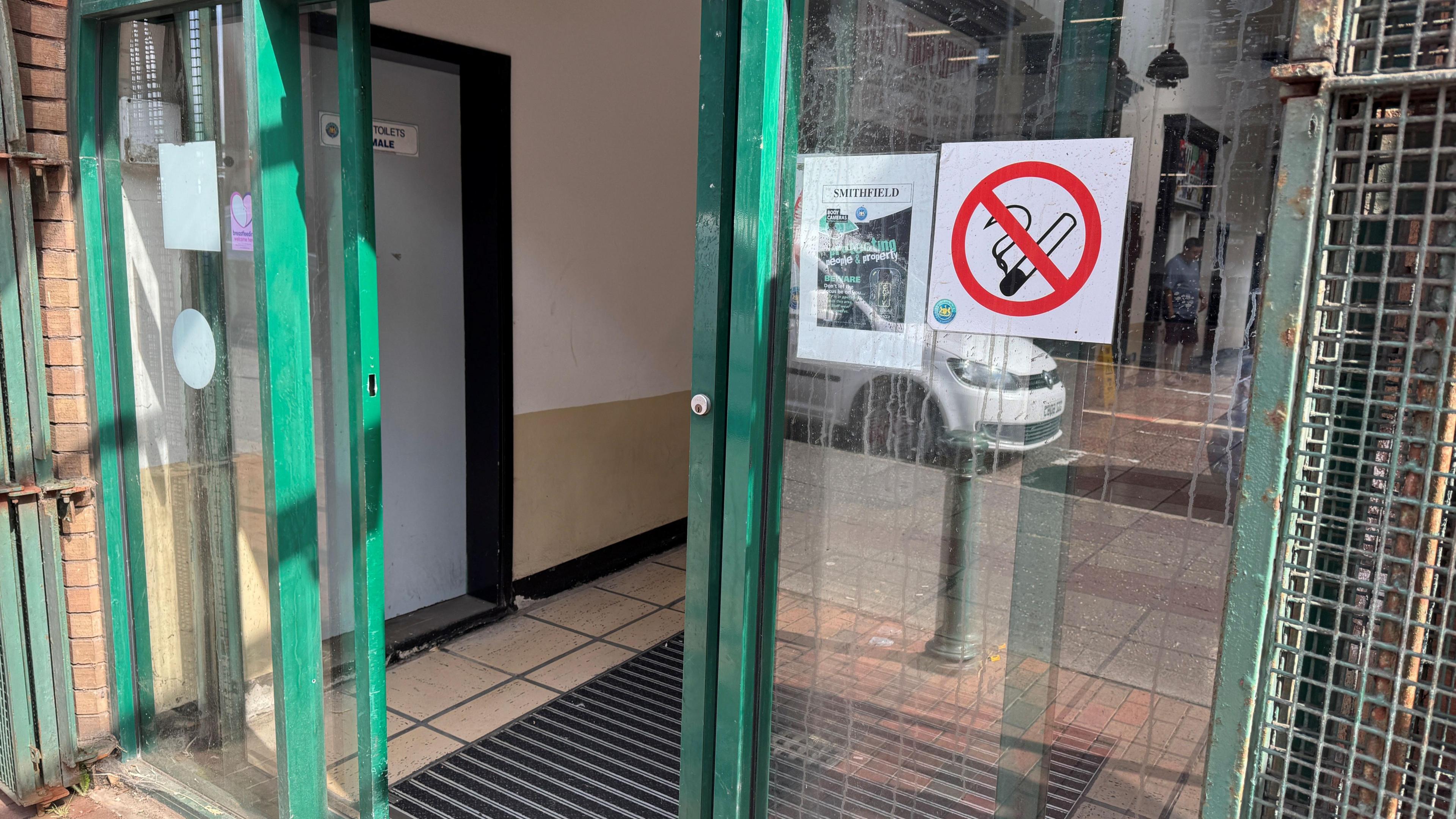 Doors to Smithfield Market that show dirt on the windows