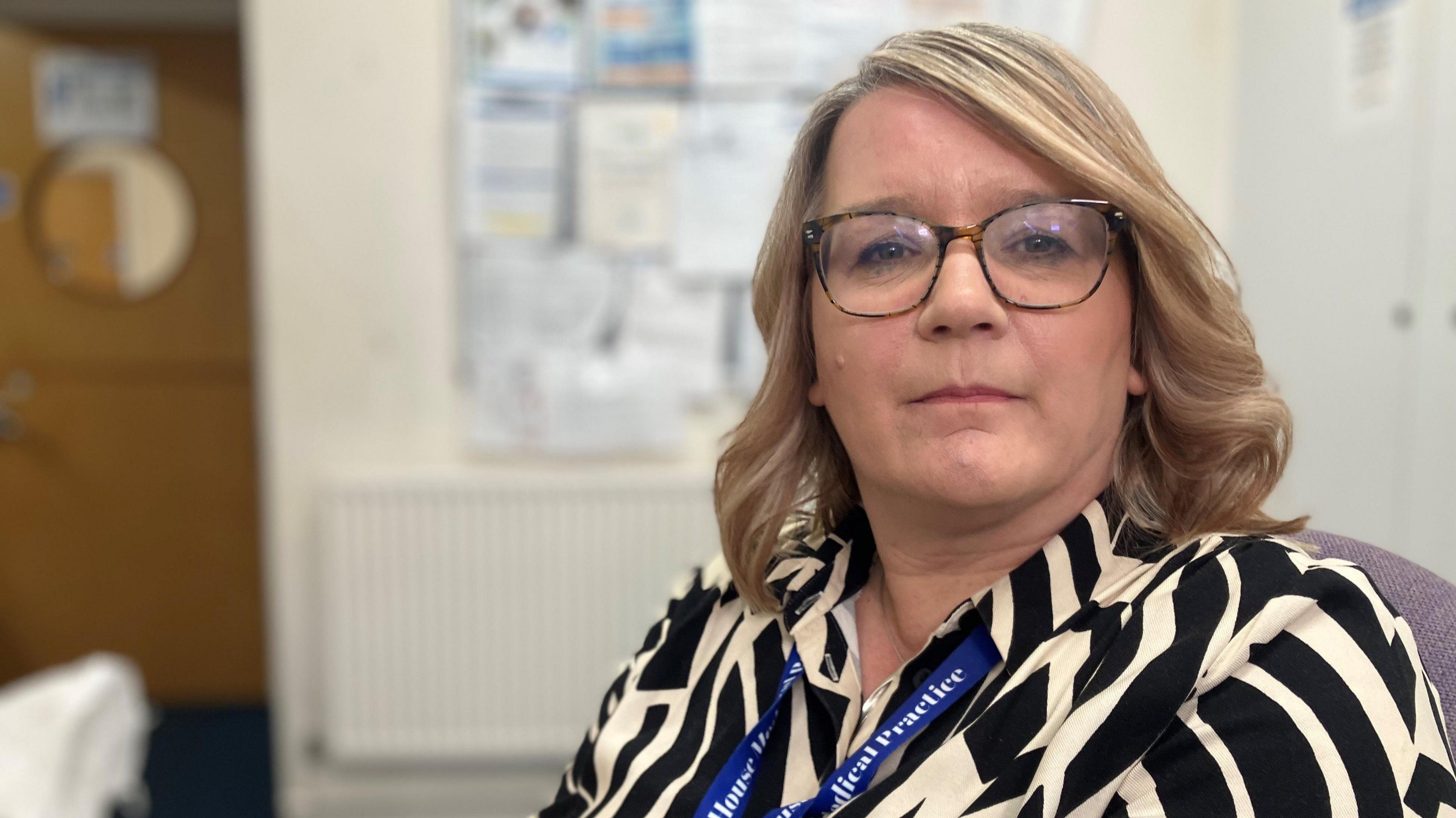 Tricia Gibbons is the manager of the Tudor House Medical Centre in Nottingham and is sat behind the main reception area. 