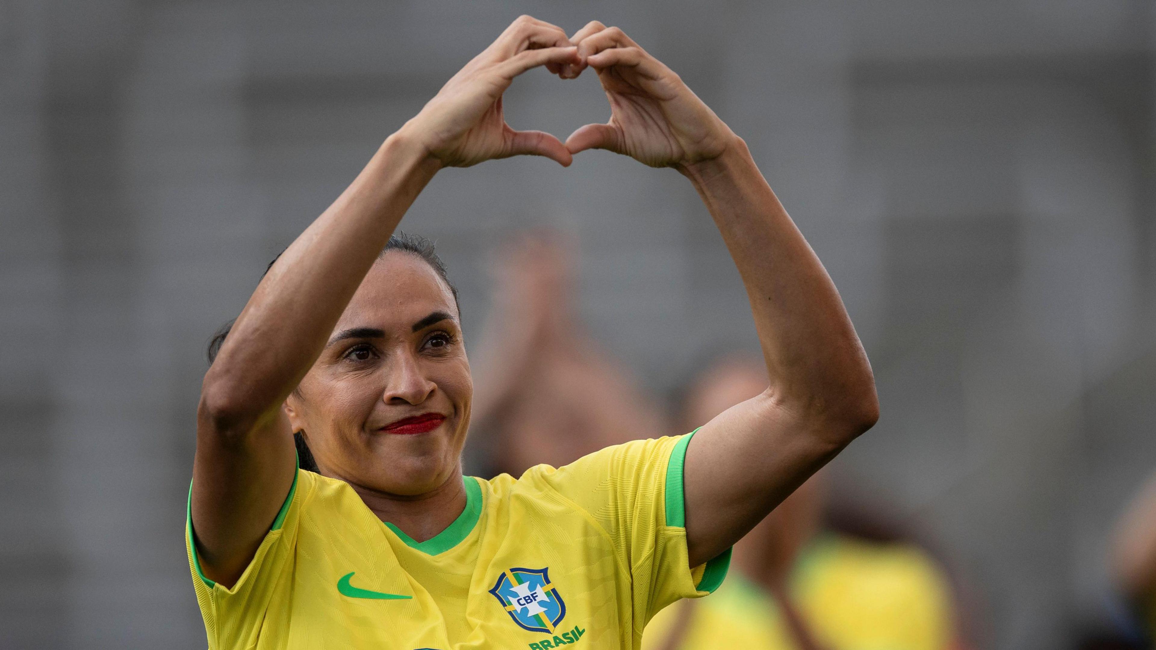 Marta makes a heart sign with her hands