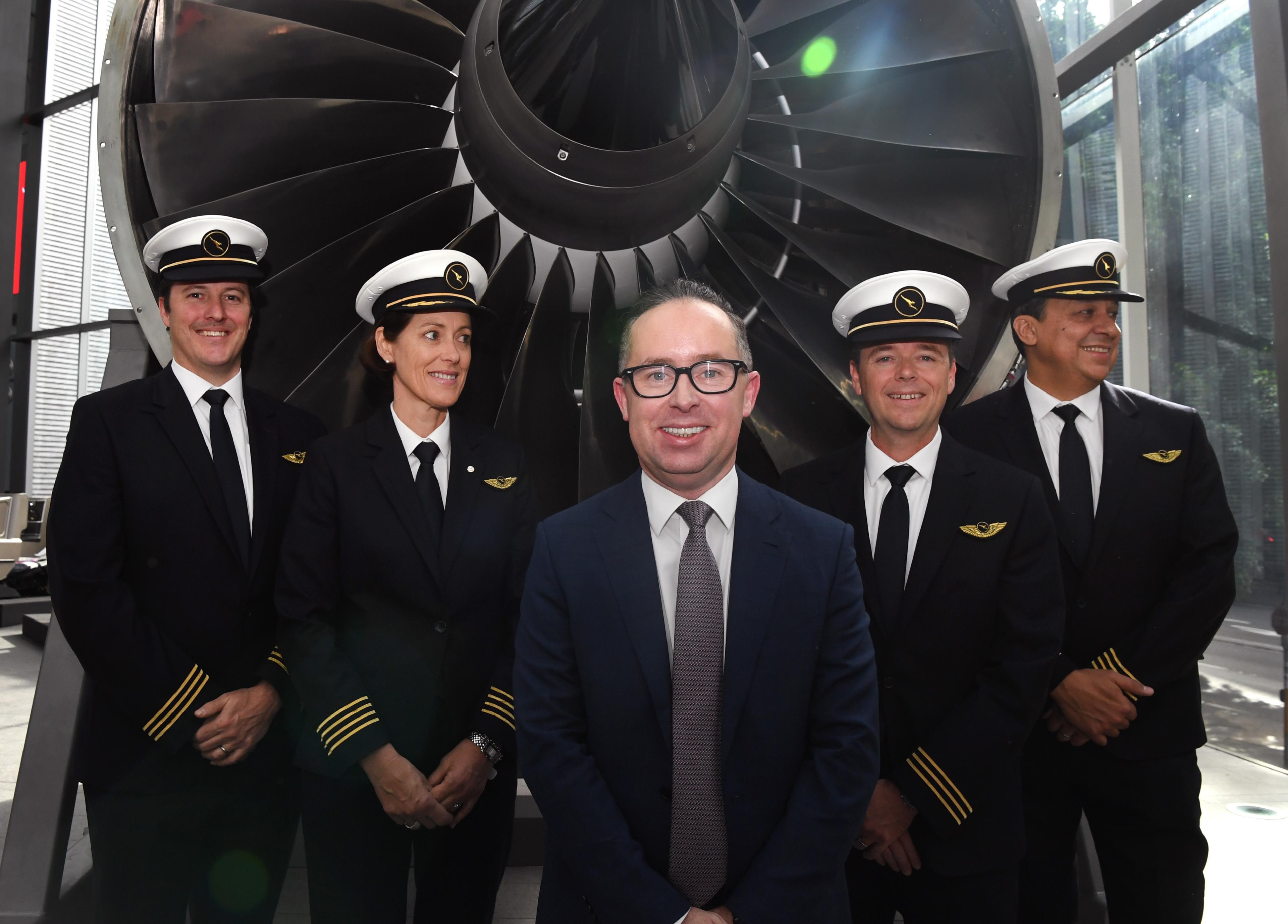 Qantas CEO Alan Joyce stands with staff