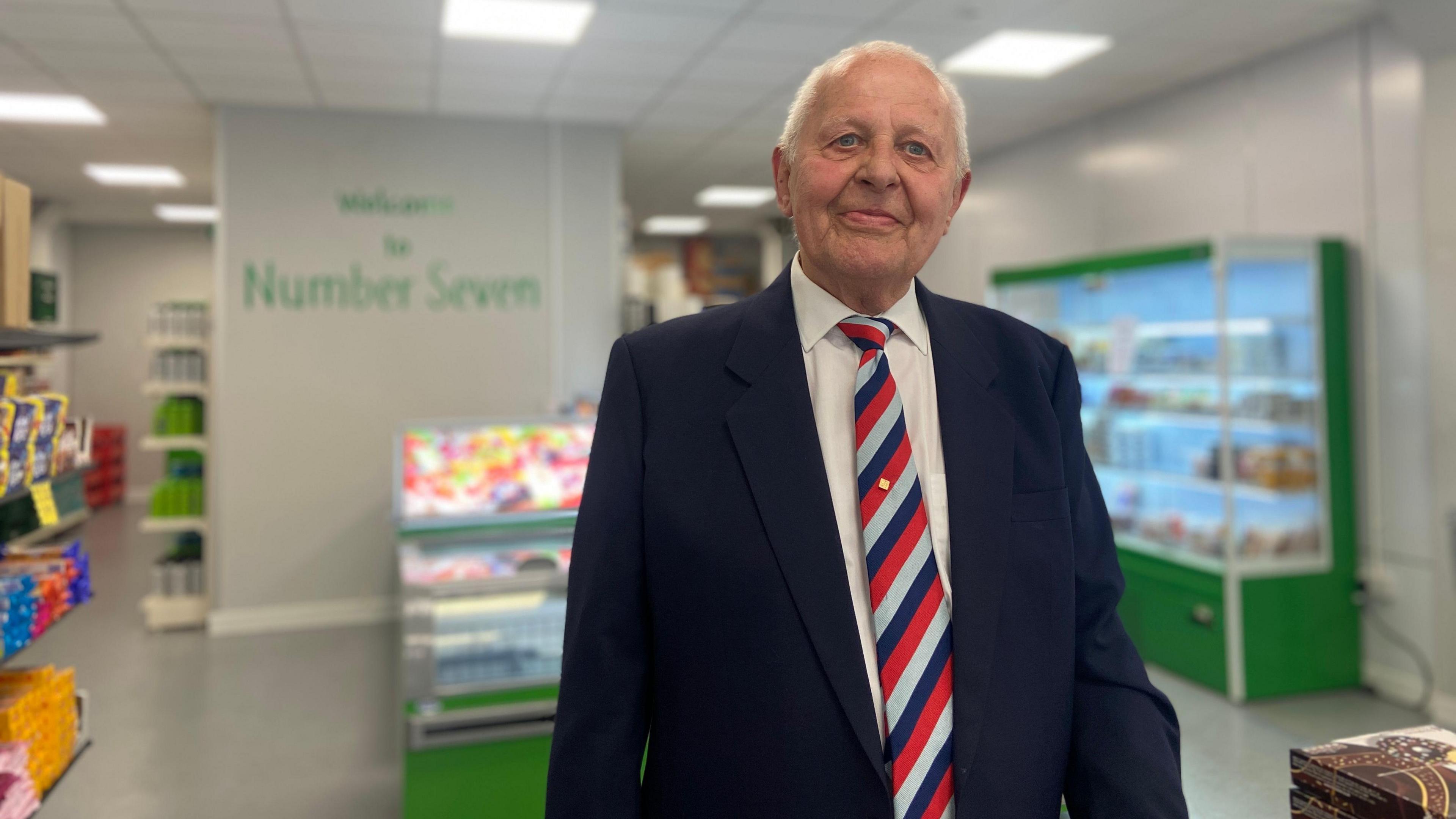 Peter Field in a suit and tie looking into the camera