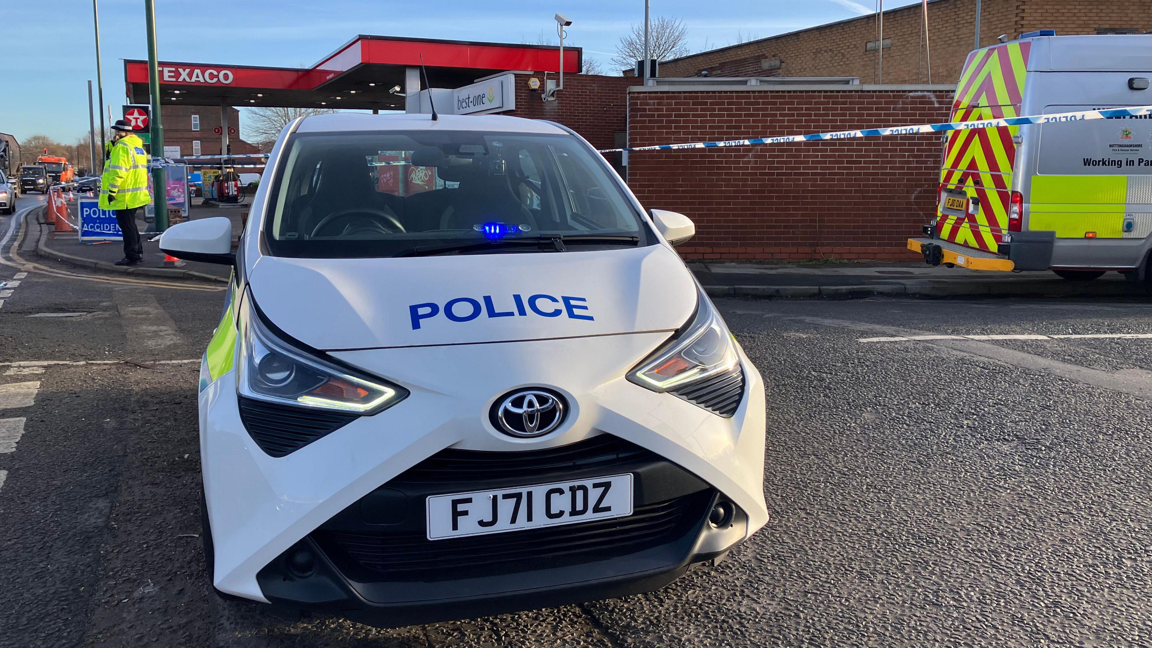 A police car and cordon at the scene of the fatal stabbing