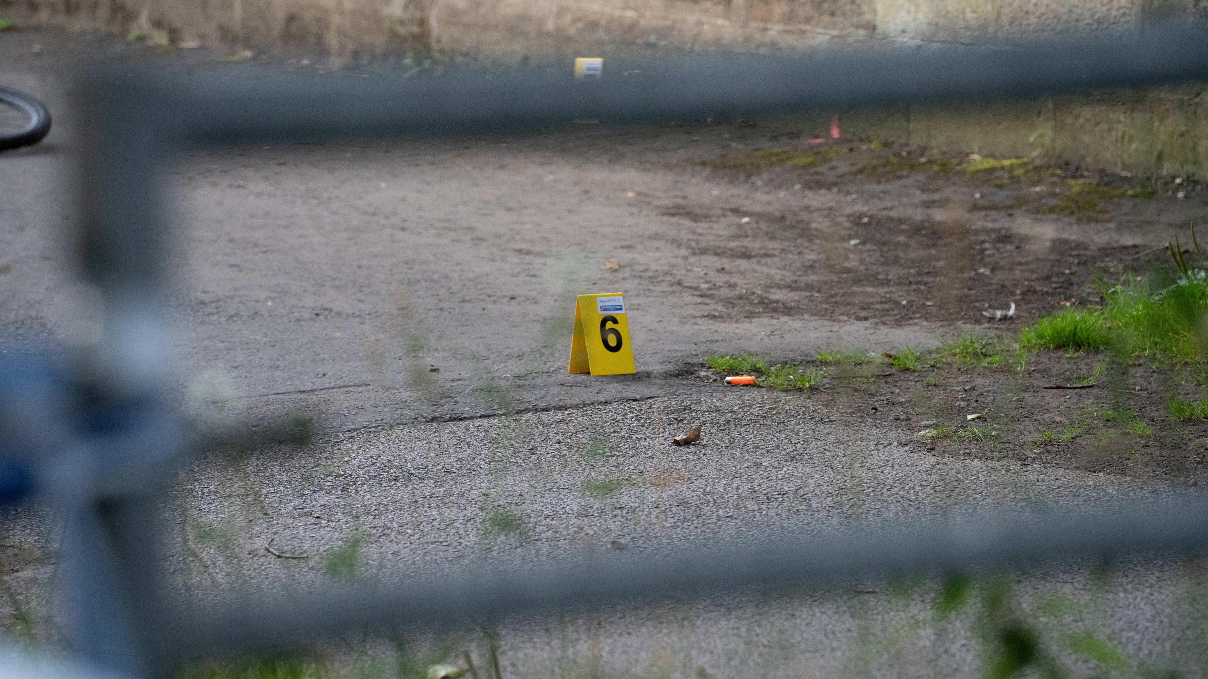 An orange lighter on the floor with an evidence marker next to it