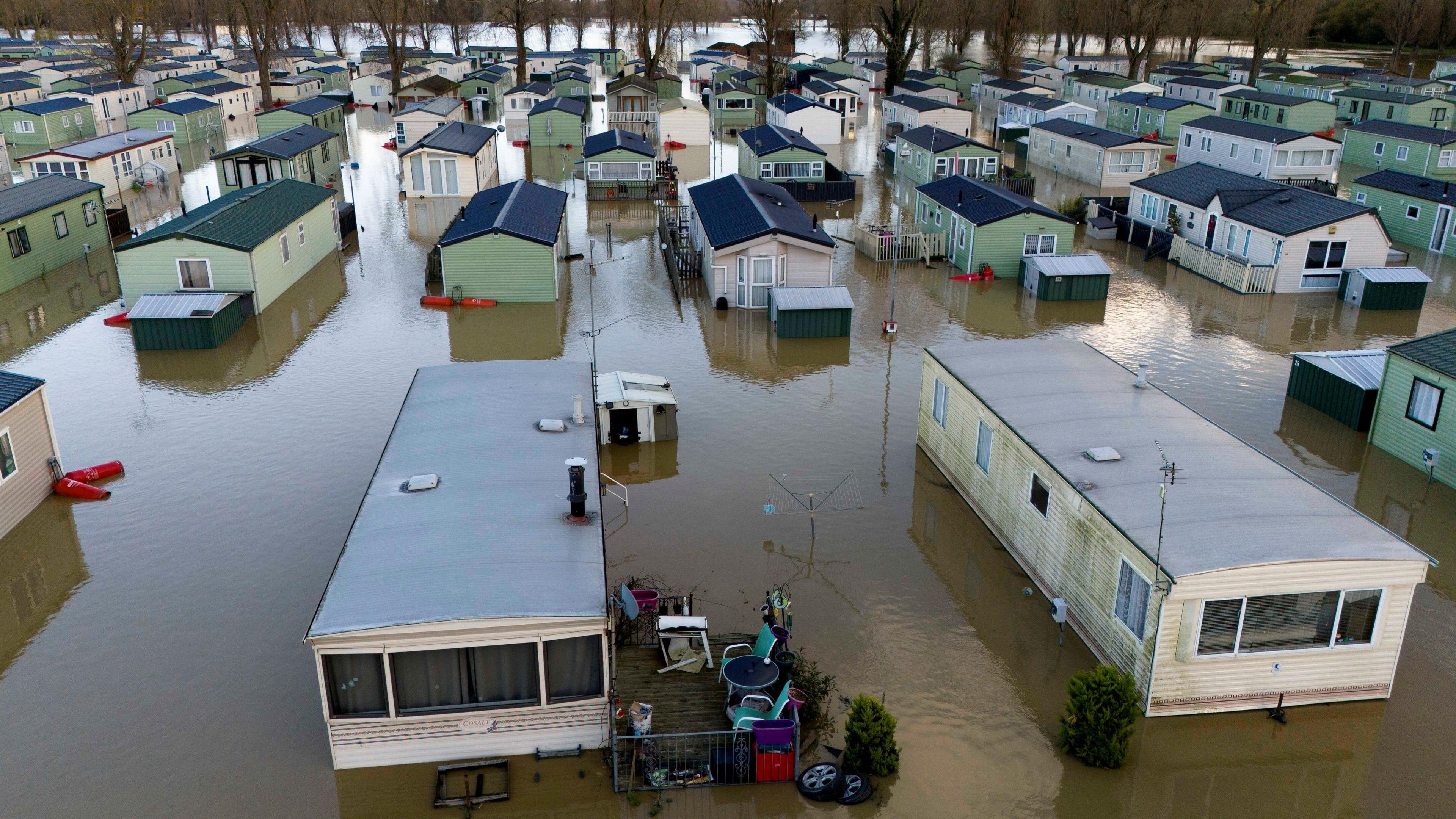 Rows of static caravans standing in flood water