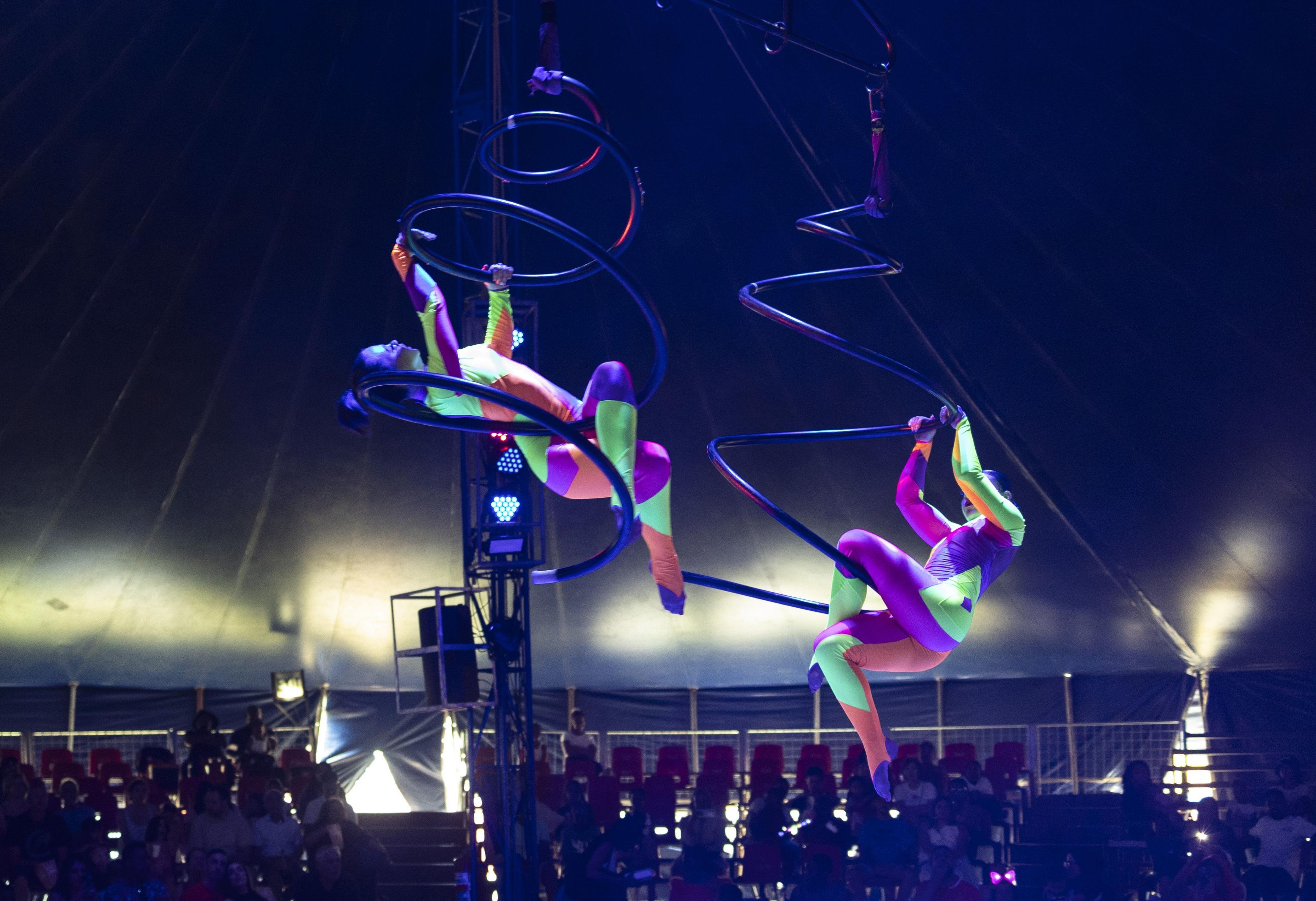 Aerial performers wearing neon-coloured bodysuits do their routine for an audience at an all-human circus in Johannesburg, South Africa - Monday 16 December 2024.