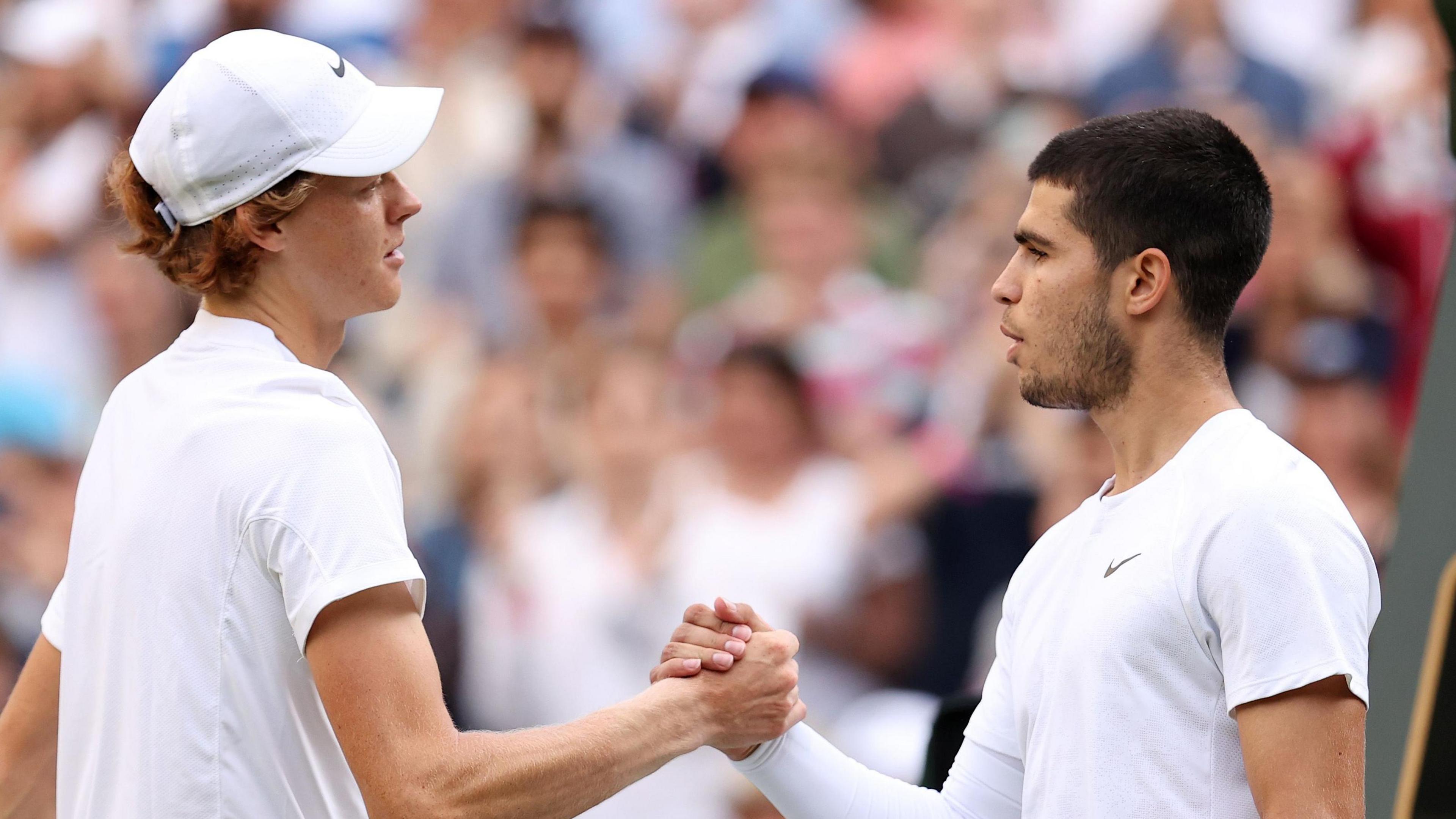 Jannik Sinner shakes hands with Carlos Alcaraz after their 2022 match at Wimbledon