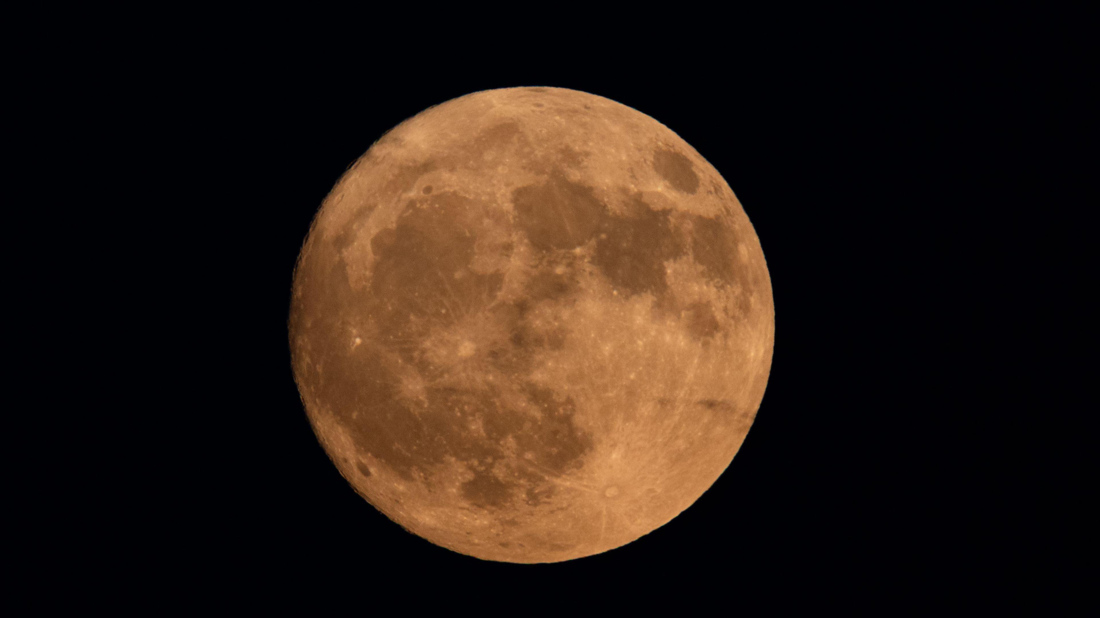 Buck moon appears slightly orange