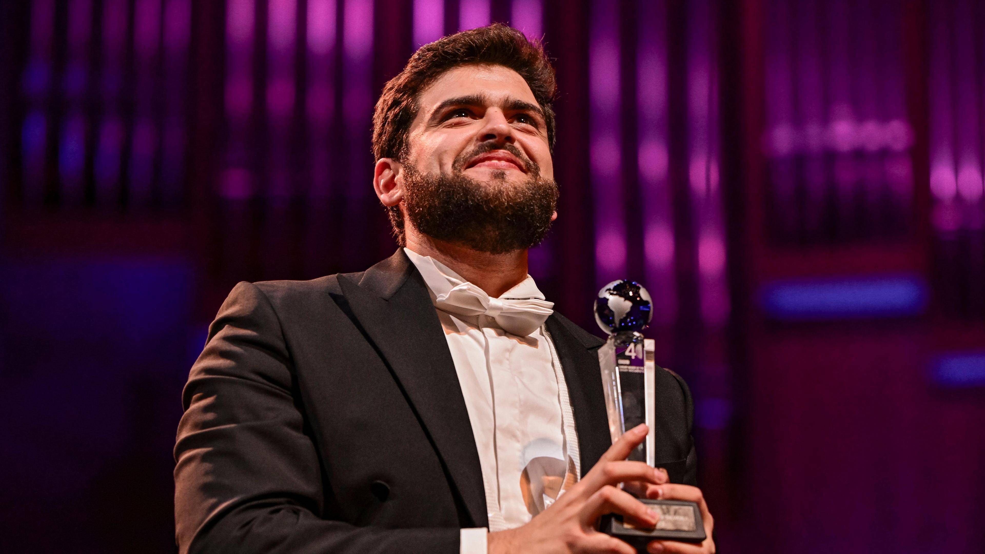 Adolfo Corrado, Cardiff Singer of the World winner in 2023, smiling as he holds his trophy