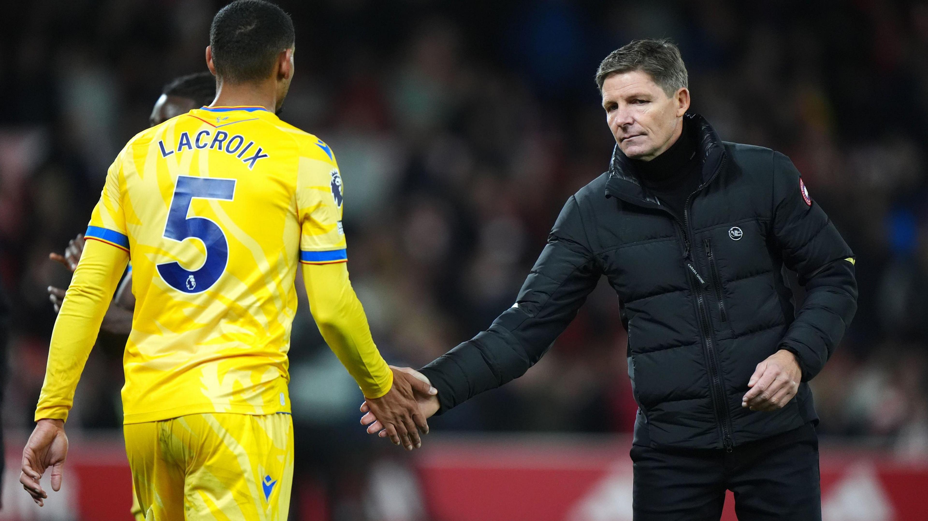 Oliver Glasner taps hands with Maxence Lacroix after a Crystal Palace defeat