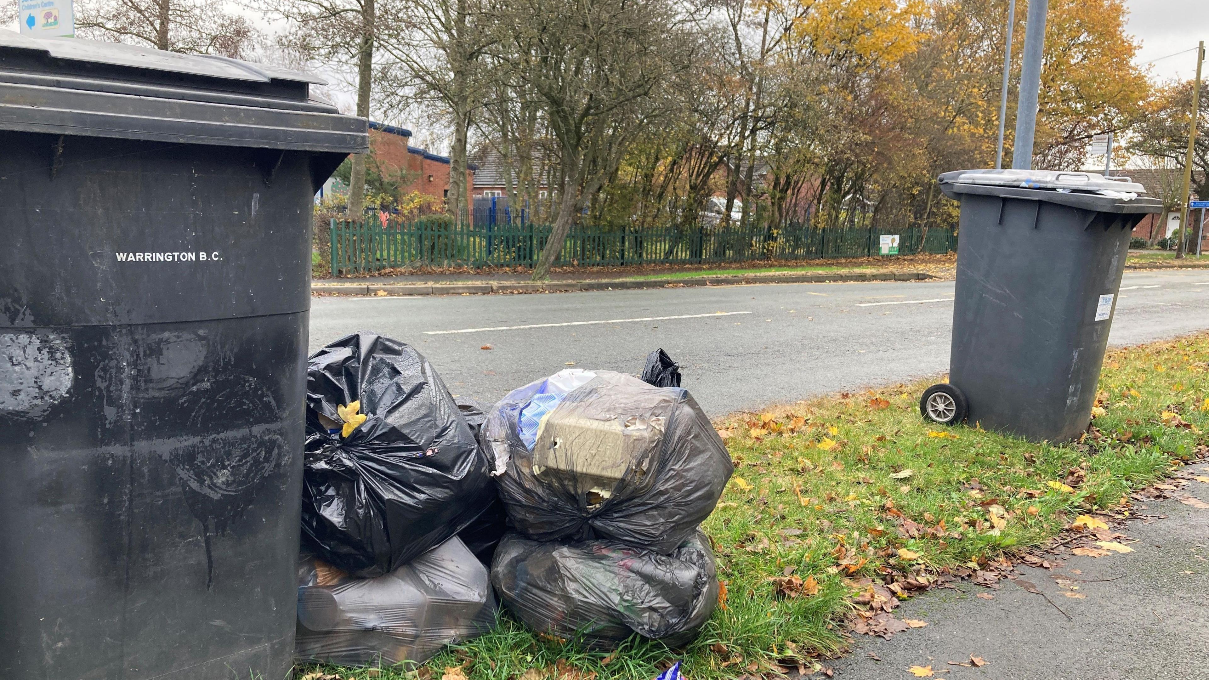 rubbish next to bins in Warrington