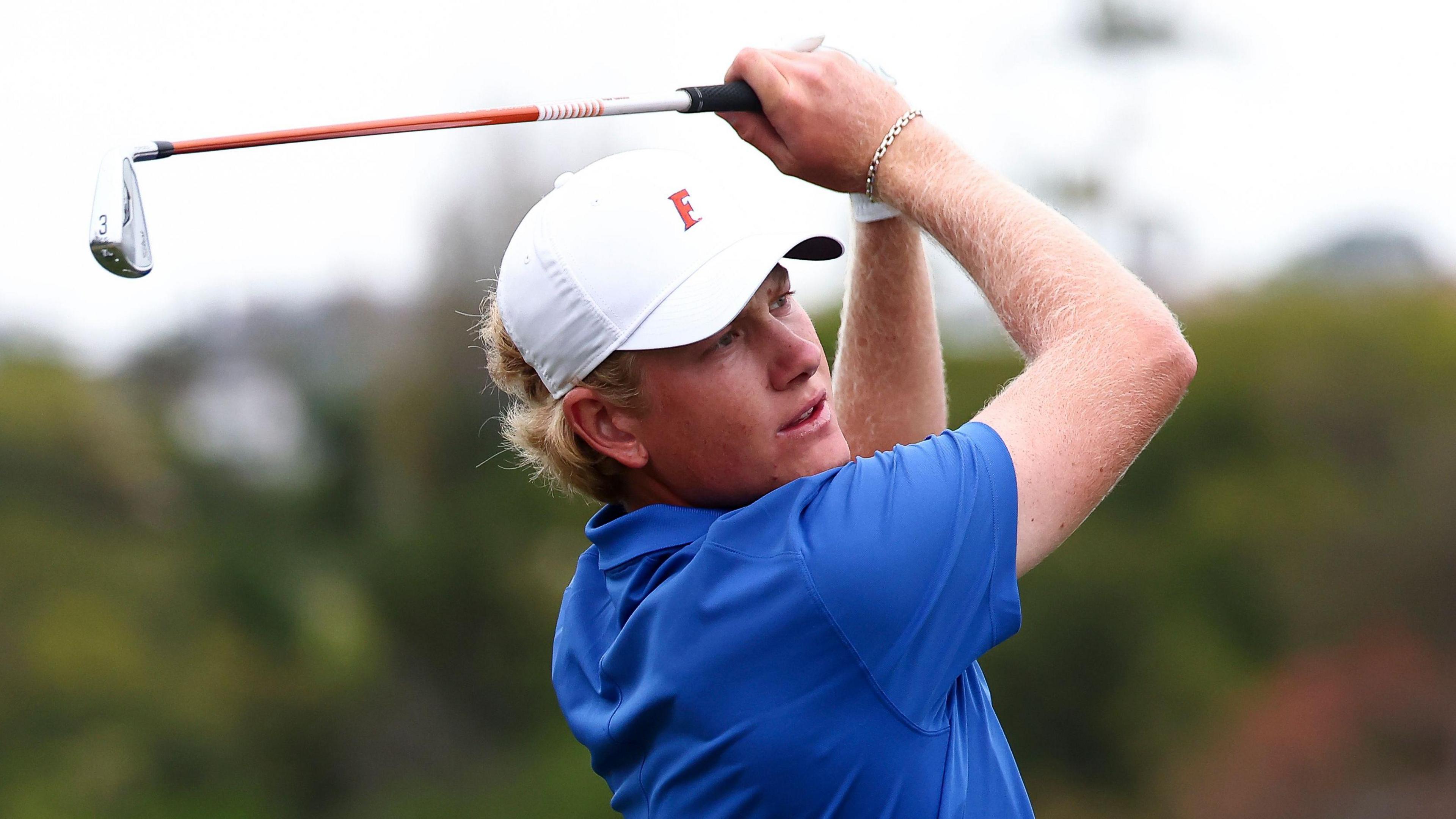 Golfer Luke Poulter hits a shot