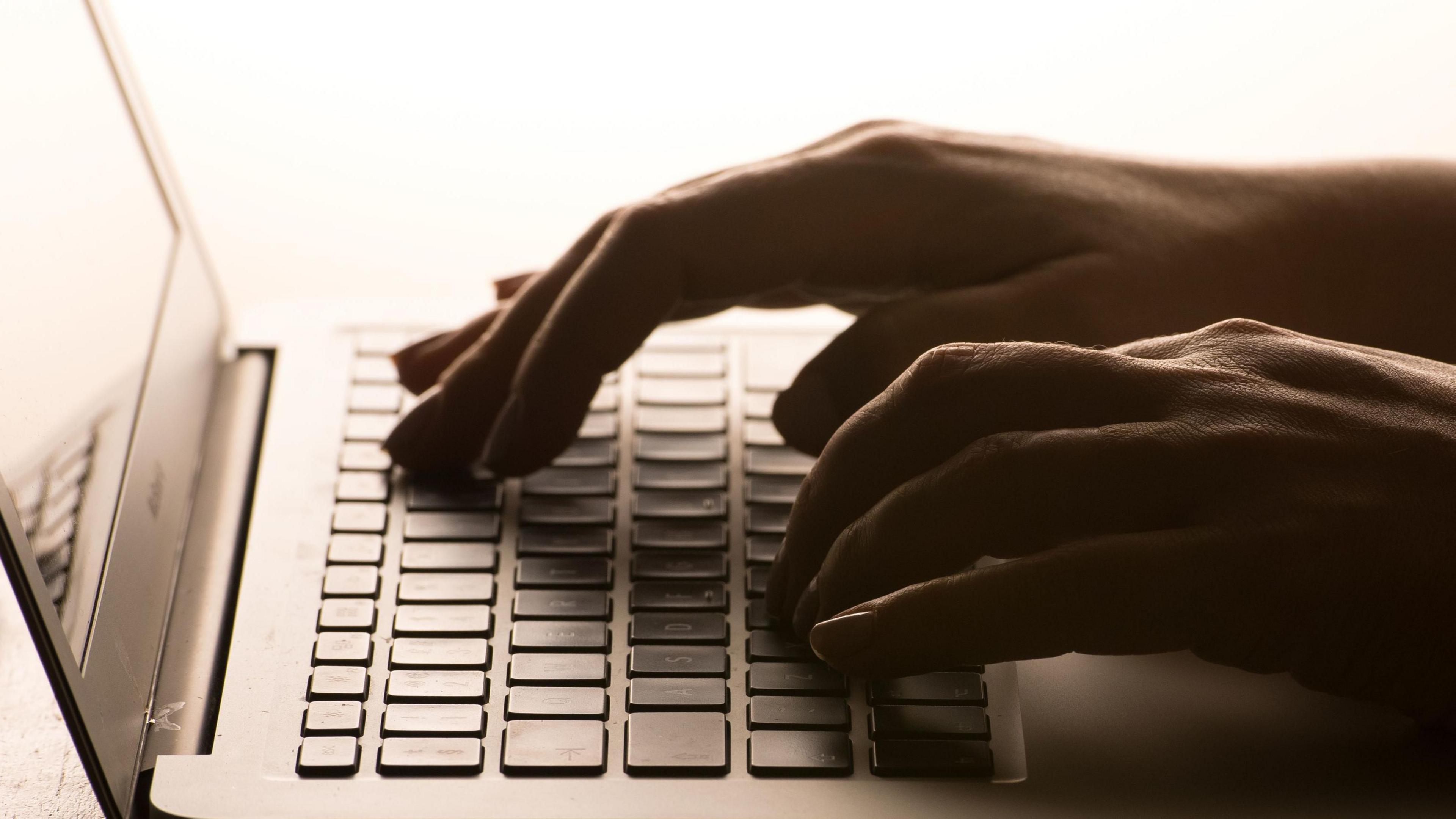 Hands typing on a keyboard 