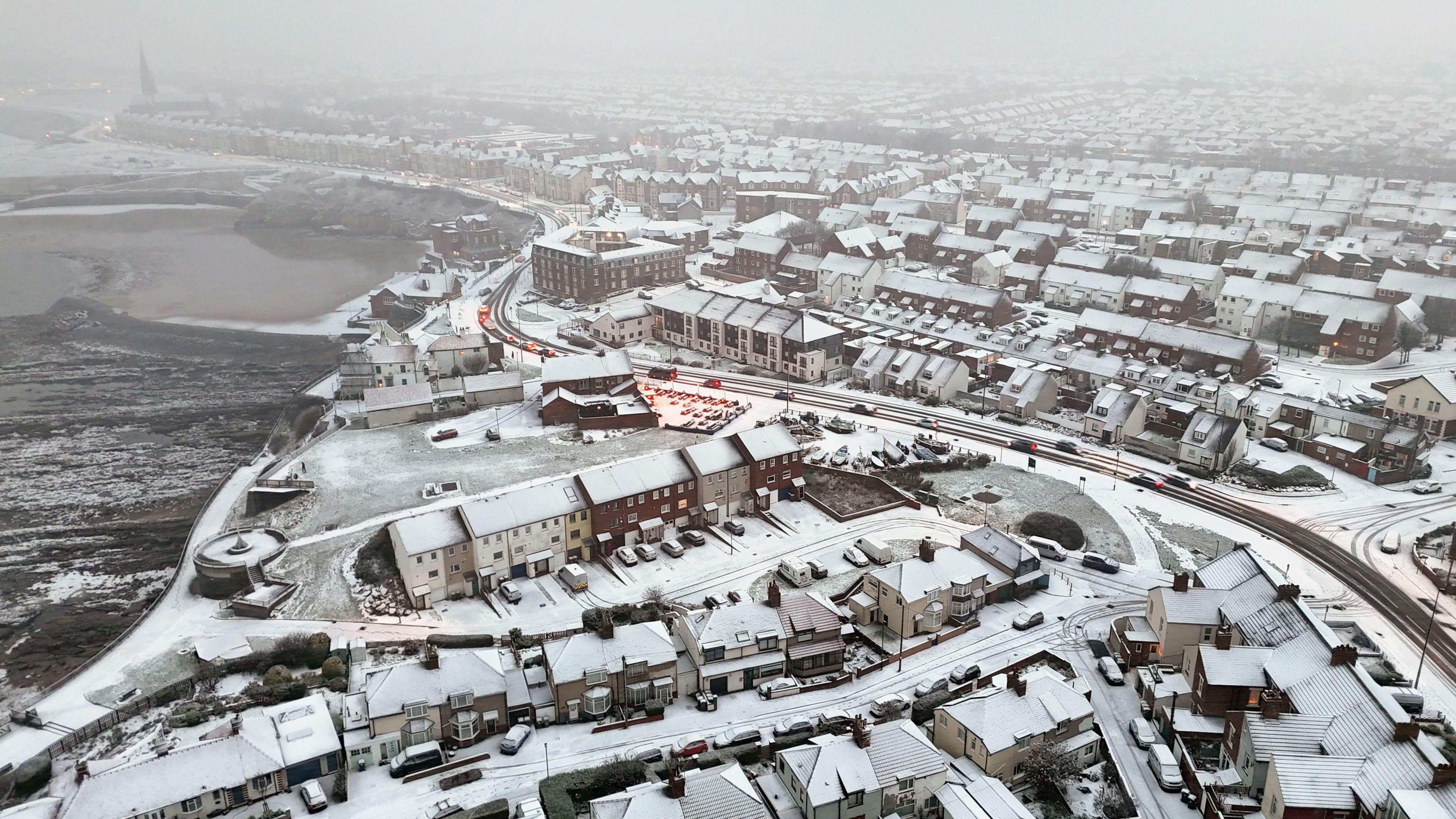 A photo of lots of houses covered with snow
