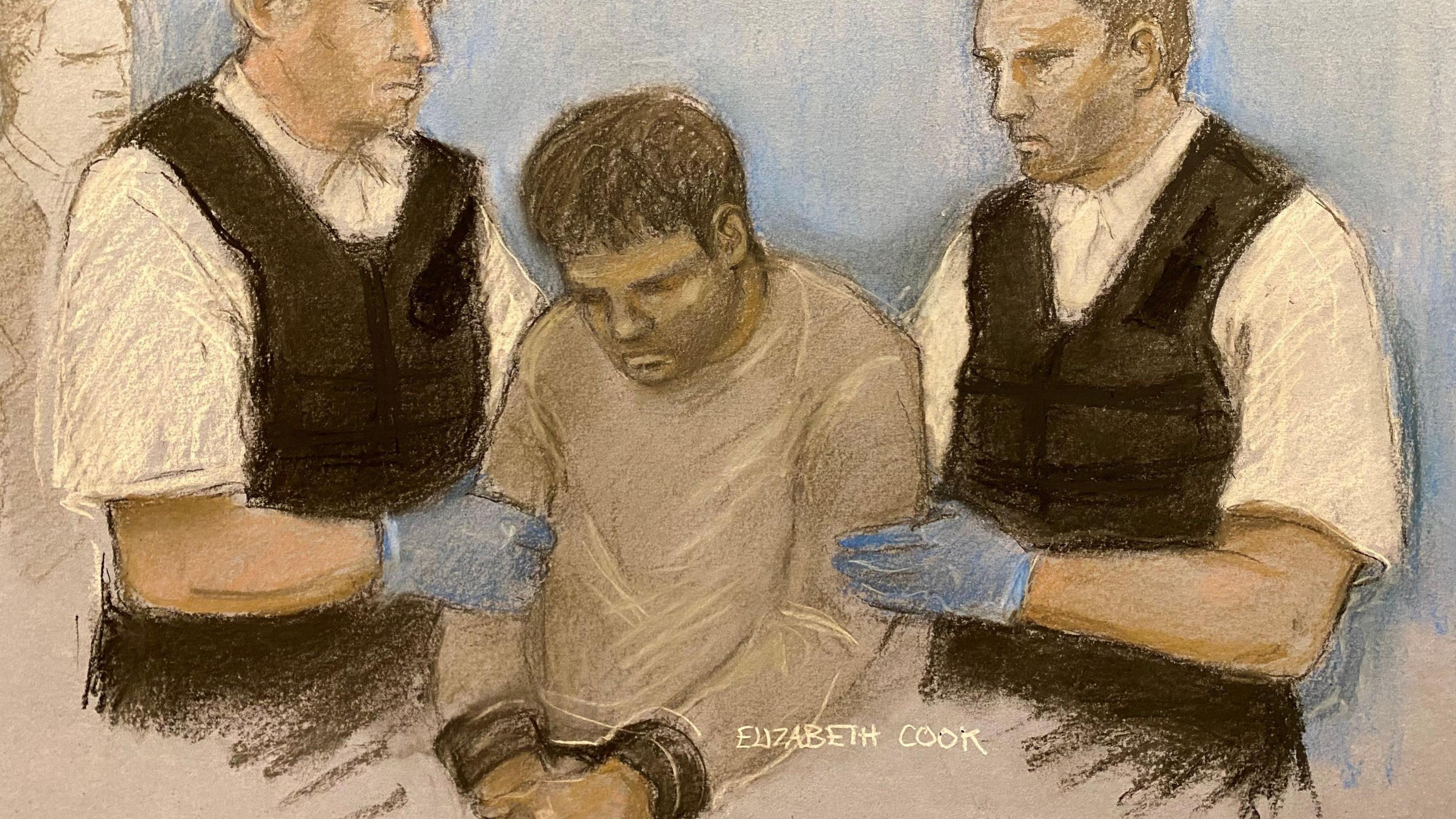 Courts Dawood Safi, dressed in a grey jumper, being led into court at Westminster Magistrates' Court by two policemen, in London in October 2025.
