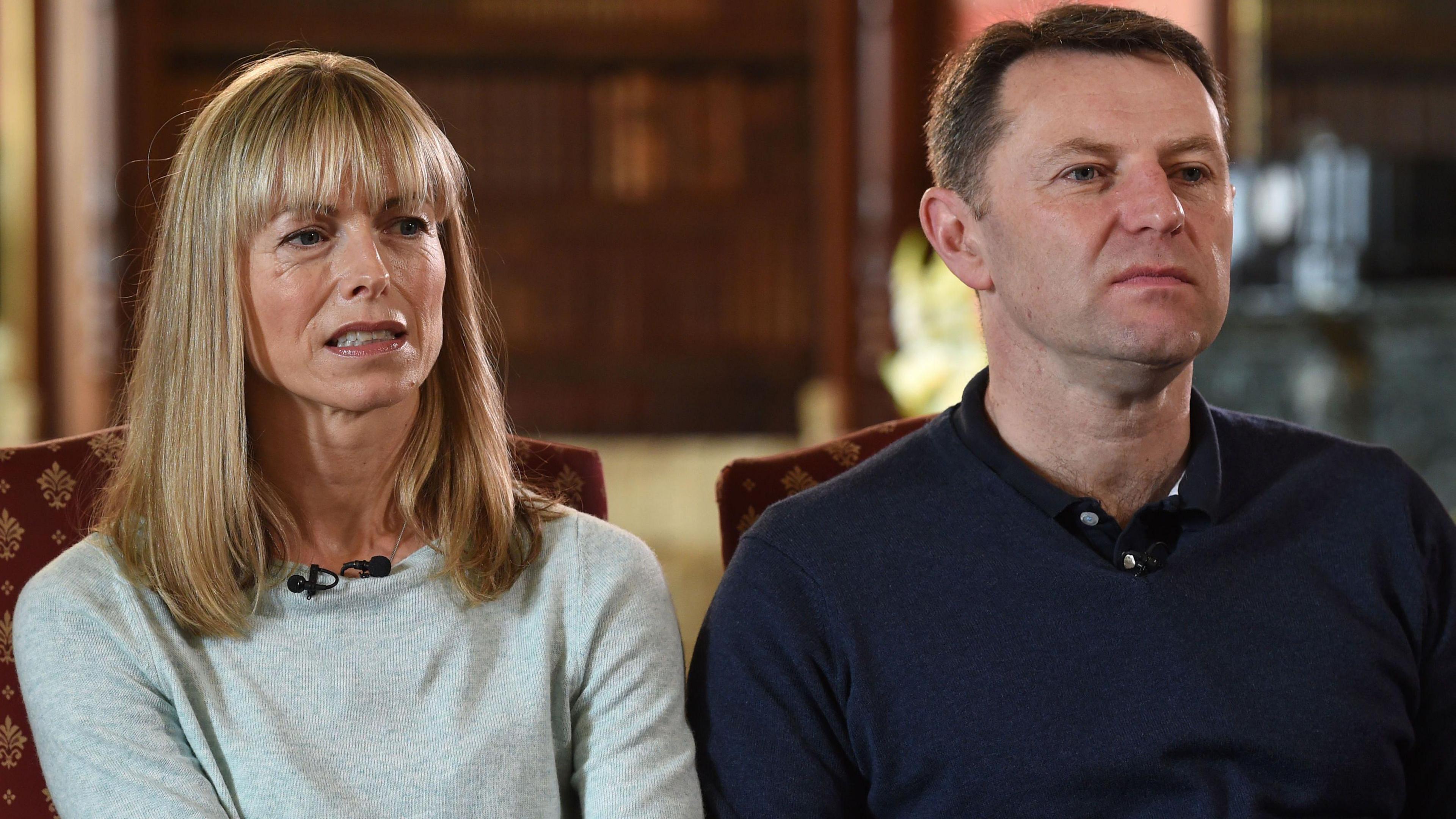 Kate McCann, in a light grey top, sits to the left of Gerry McCann, who is wearing a dark polo top and jumper