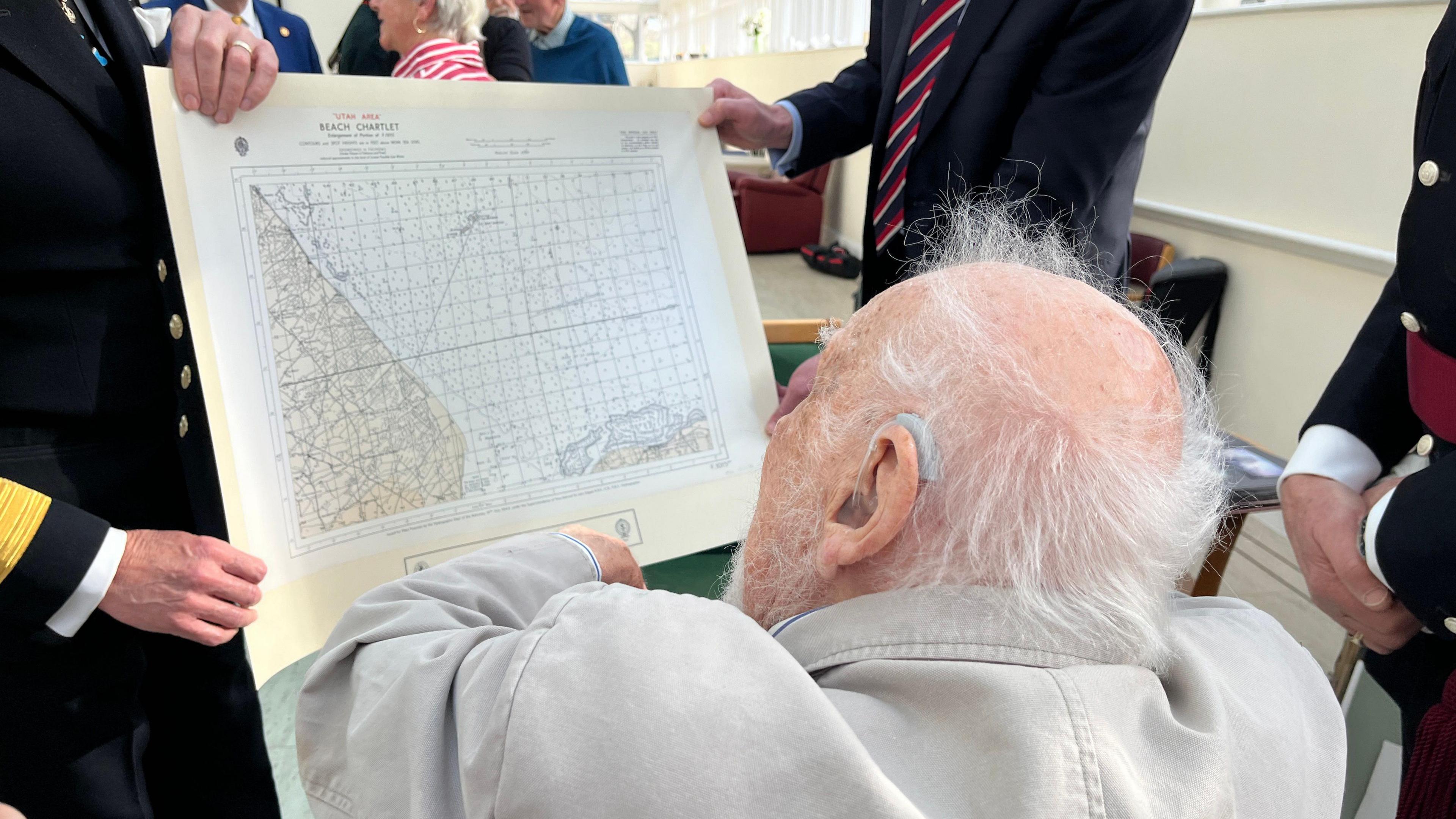 Lt Willis being presented with the original landing chart for his boat