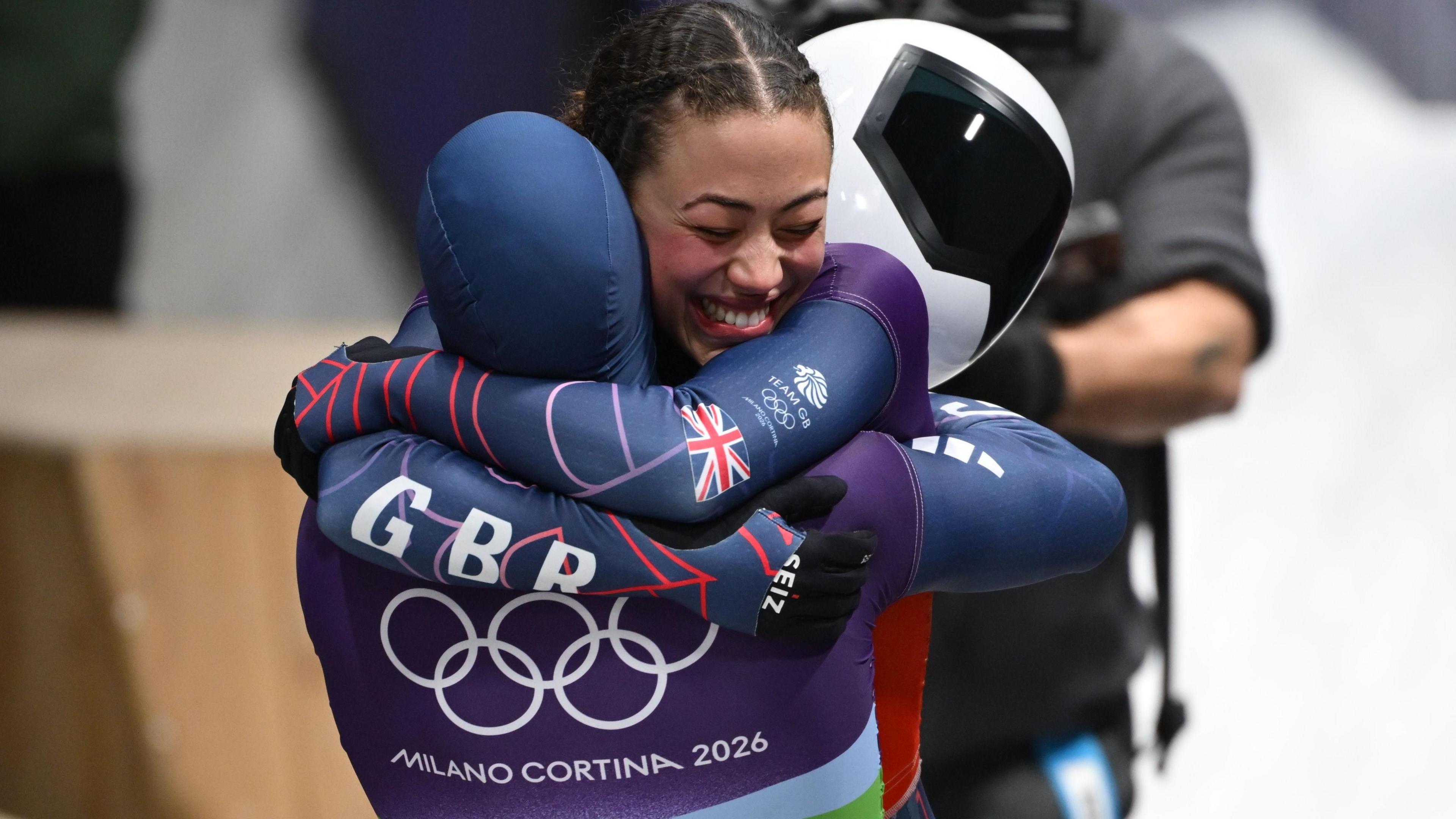 Tabitha Stoecker and Matt Weston of hug by the Skeleton track after winning the Mixed Team Skeleton event. 