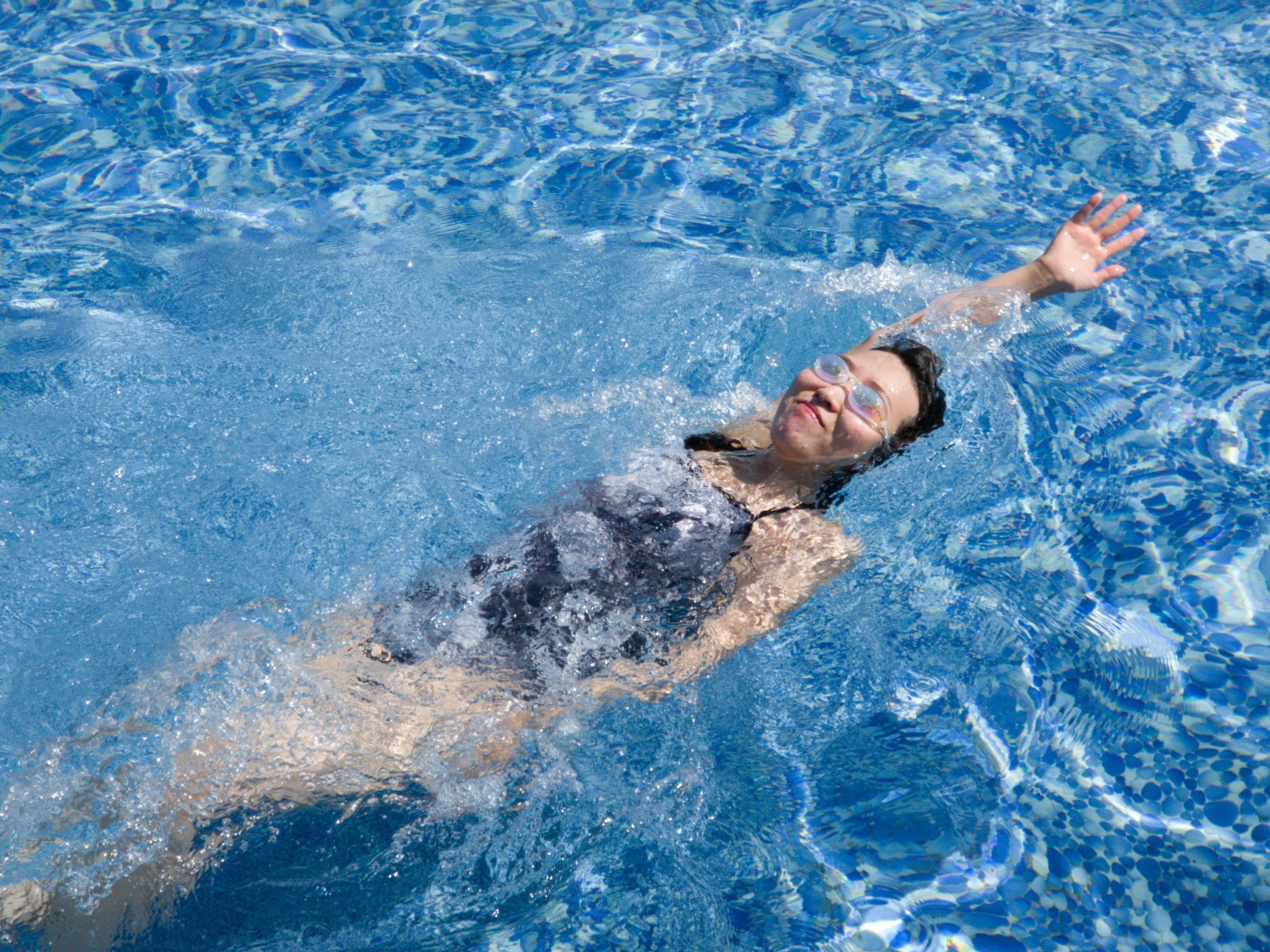 A woman swimming backstroke