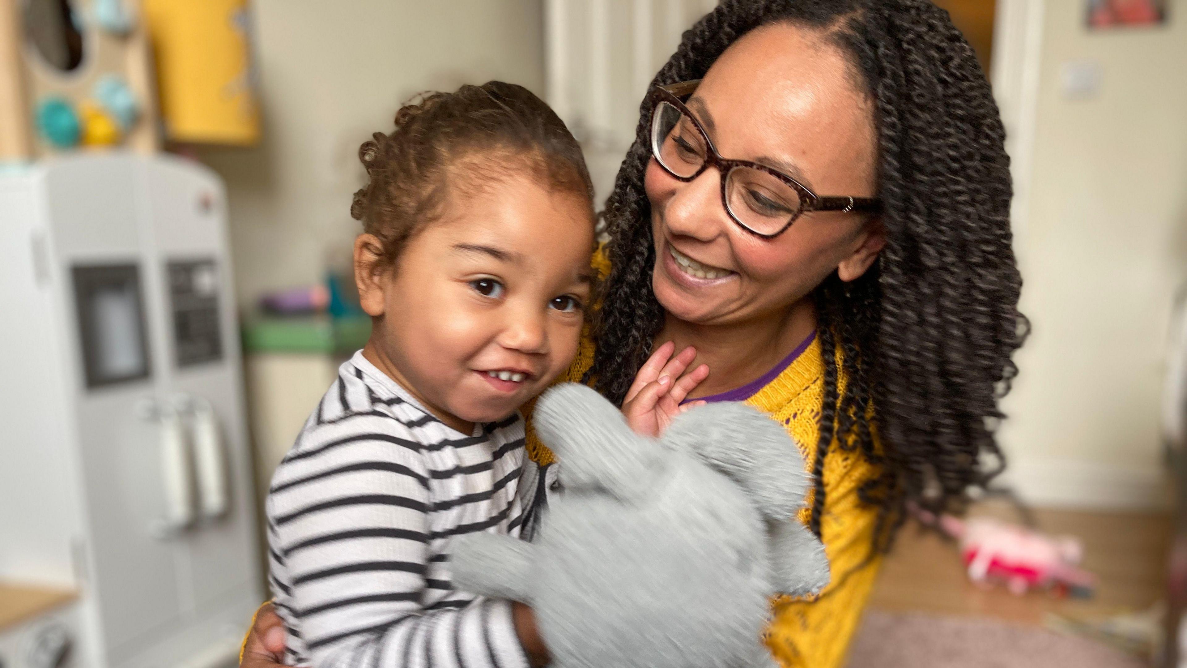 Rachel with two-year-old daughter Winnie holding a toy rabbit