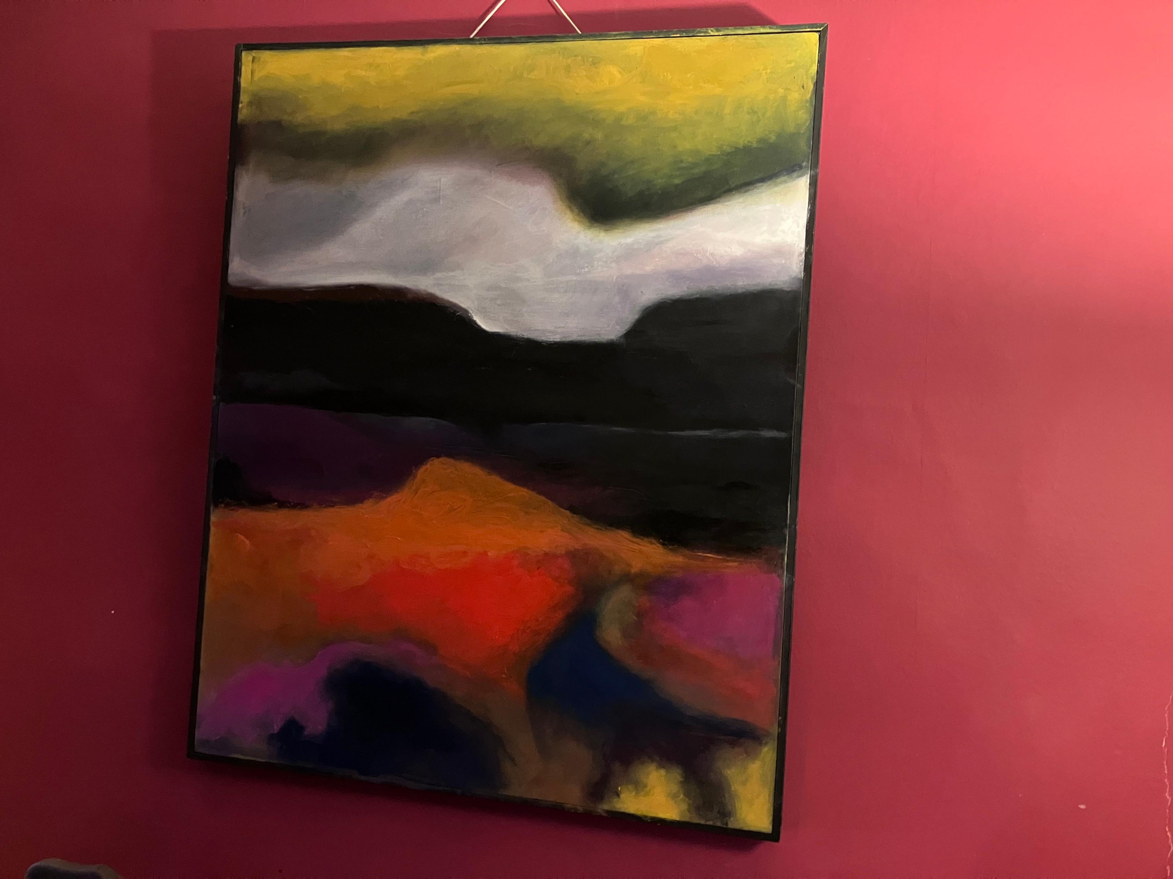 One of Glenys' paintings. It is an abstract landscape with yellow, white, pink, red and orange irregular horizontal blocks colour. It is handing on the pink wall of her living room. 