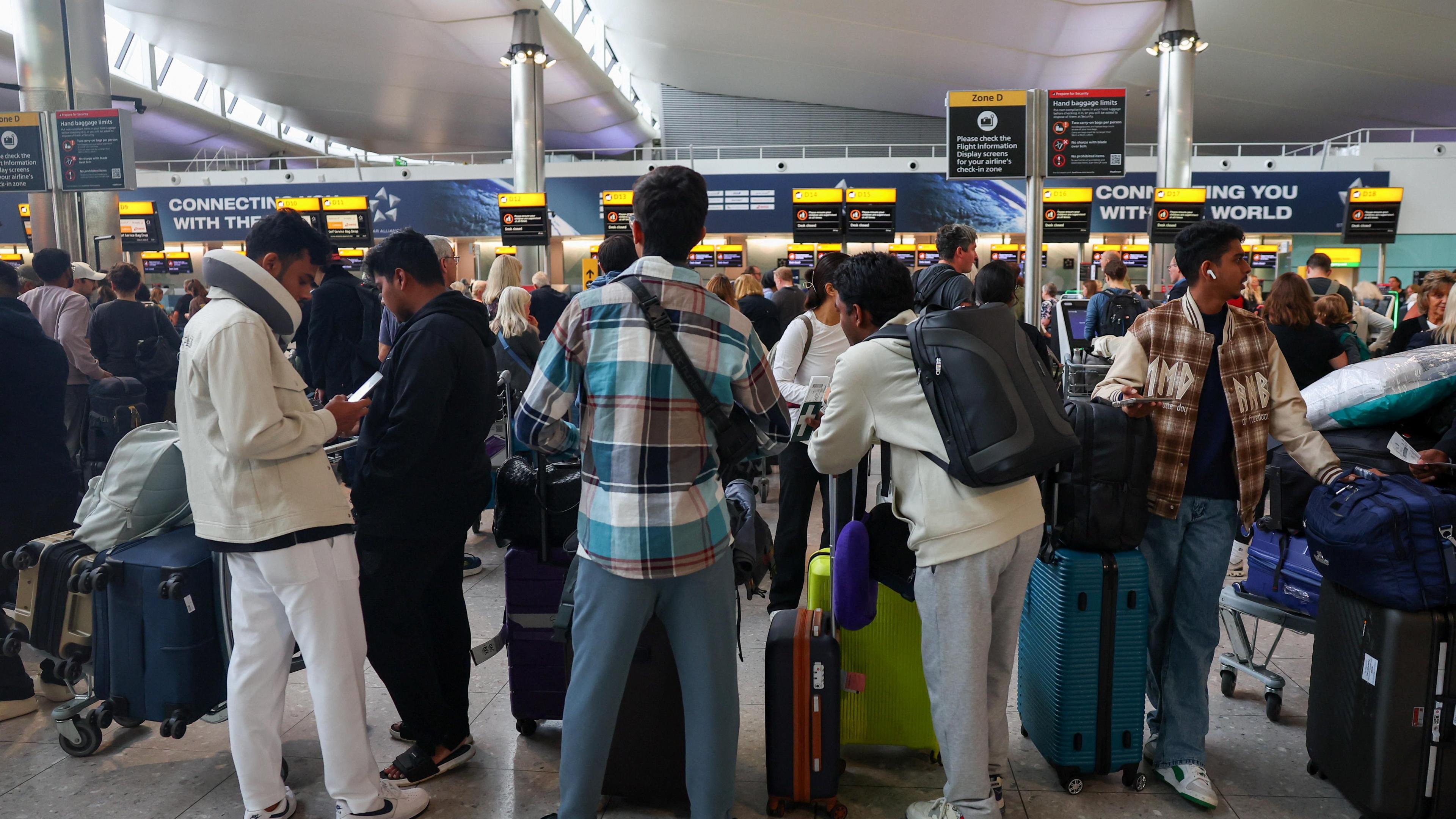 A picture of a check-in area at Heathrow on Saturday morning, filled with busy rows of people queuing up.