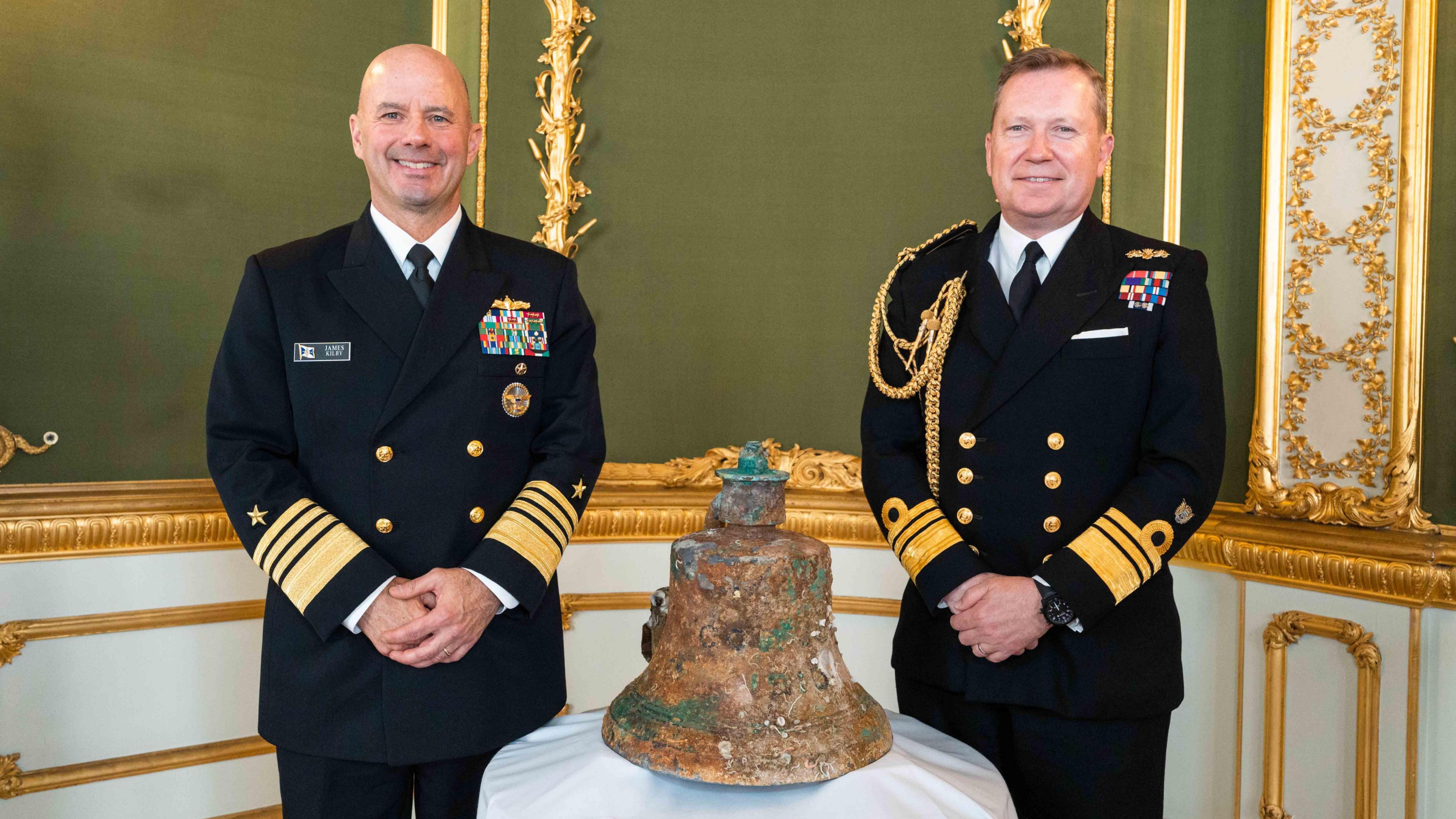 Admiral James W. Kilby, the US Navy’s Vice Chief of Naval Operations, and Vice Admiral Martin Connell, the Royal Navy’s Second Sea Lord and Deputy Chief of Naval Staff, with the bell recovered from USS Jacob Jones