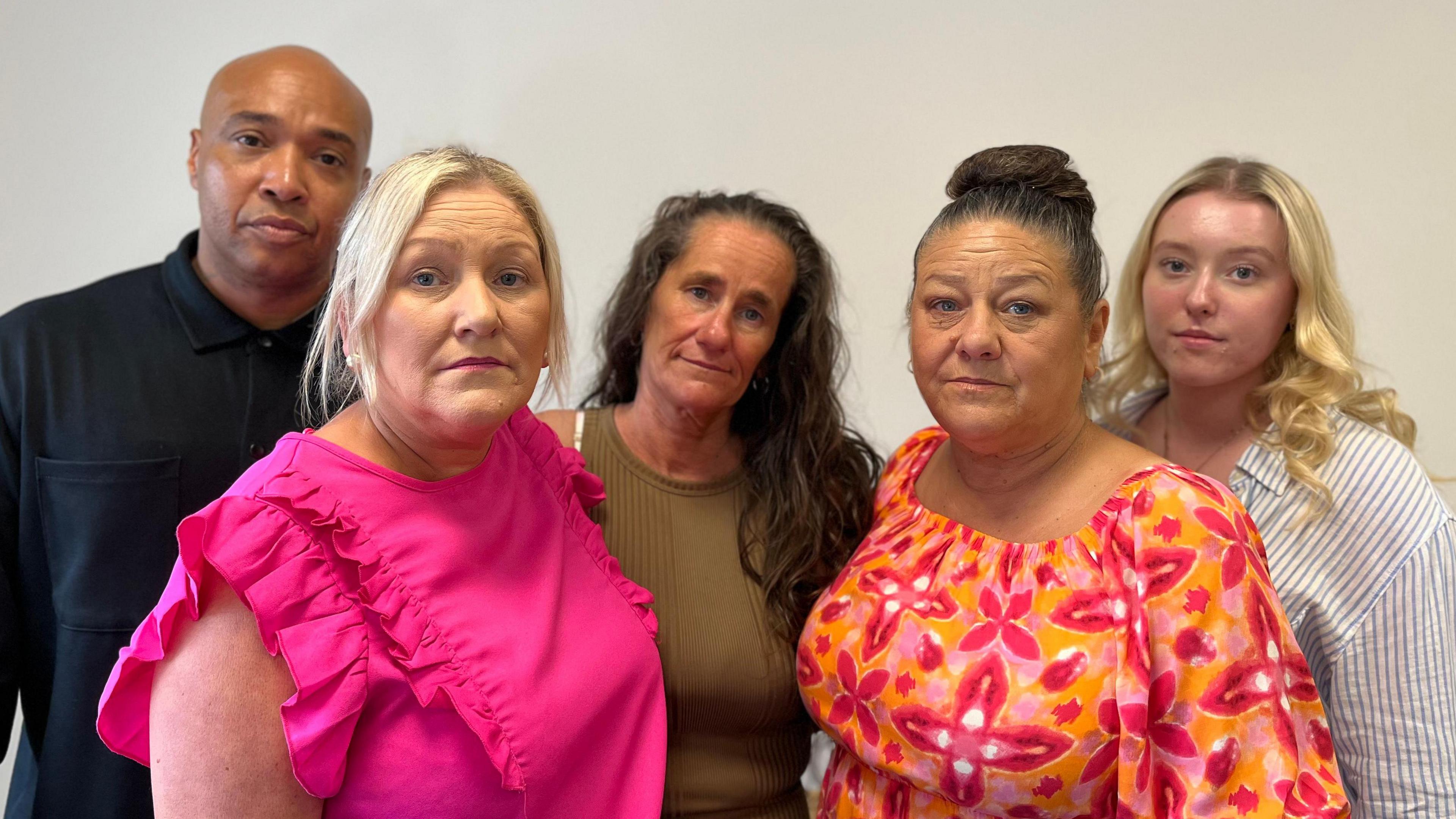 Kaine Fletcher's family. A man is pictured with four women and they are all looking at the camera.