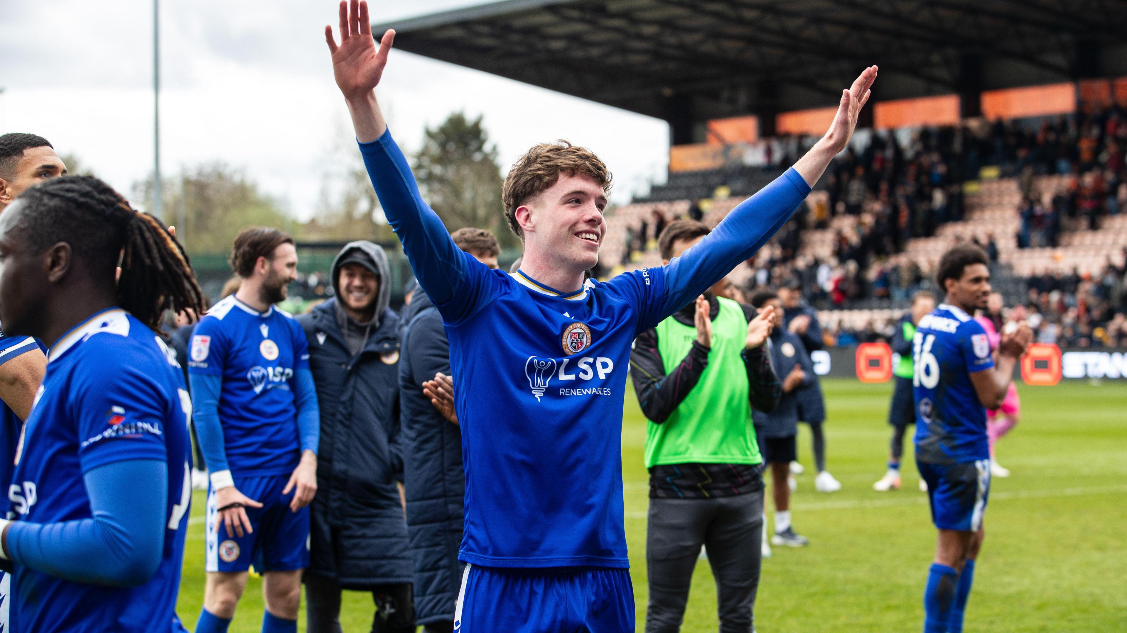 George Evans and Bromley players celebrate in front of Ravens fans at Barnet