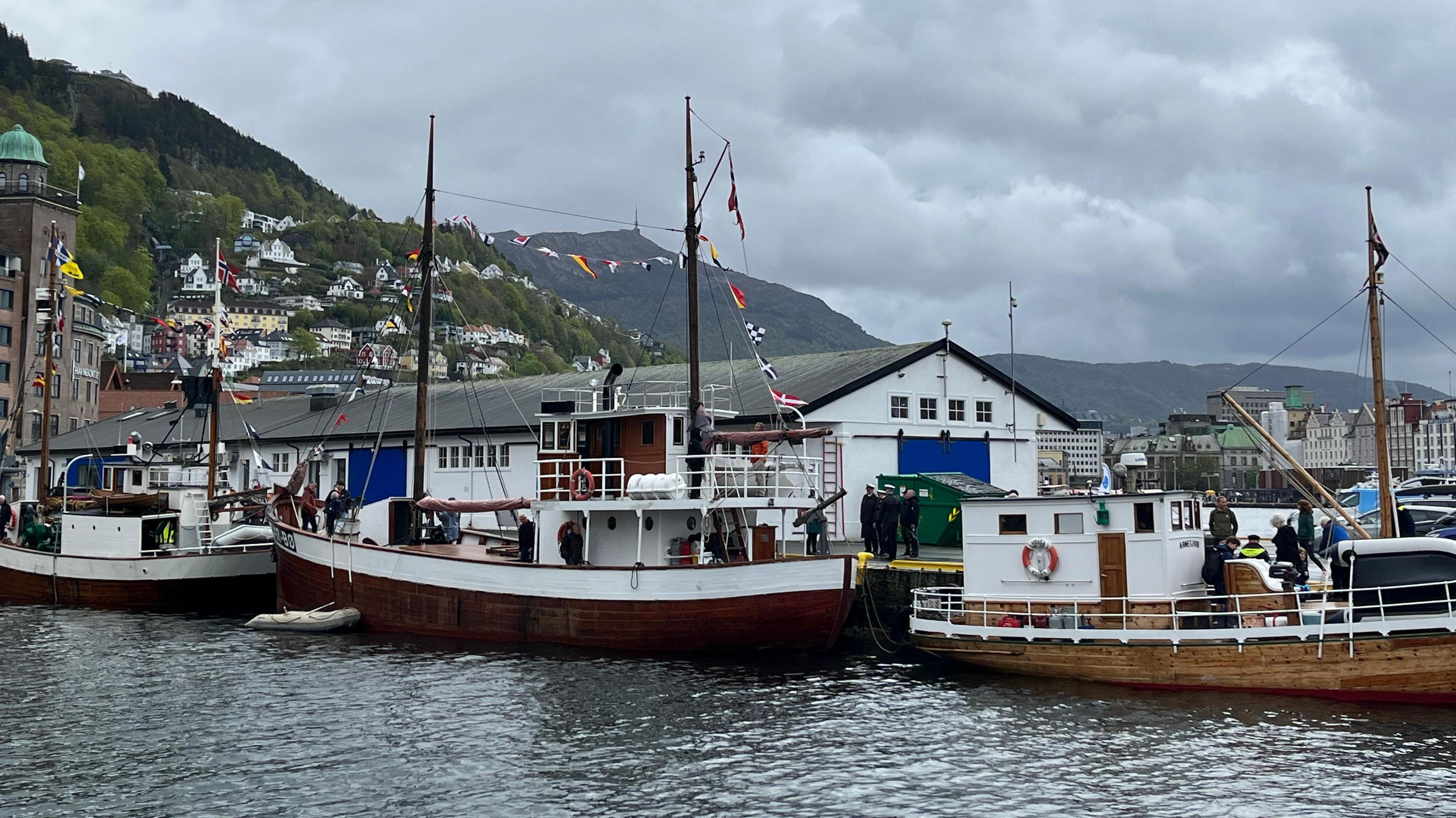 old boats with flags at a harbourside