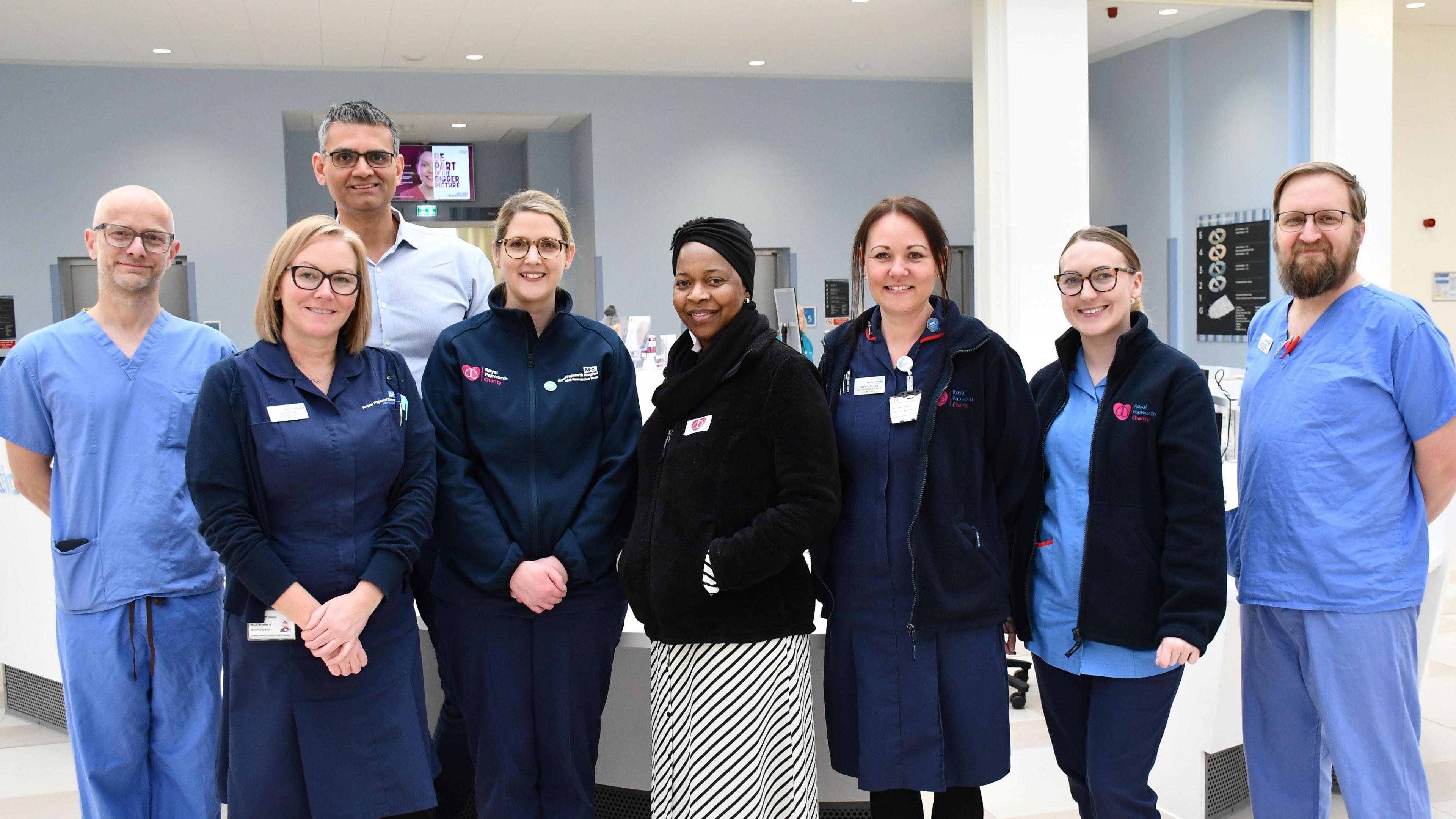 Representatives from Royal Papworth Hospital's multidisciplinary transplant team are stood in front of a receptionist desk with Ms Mushonga.