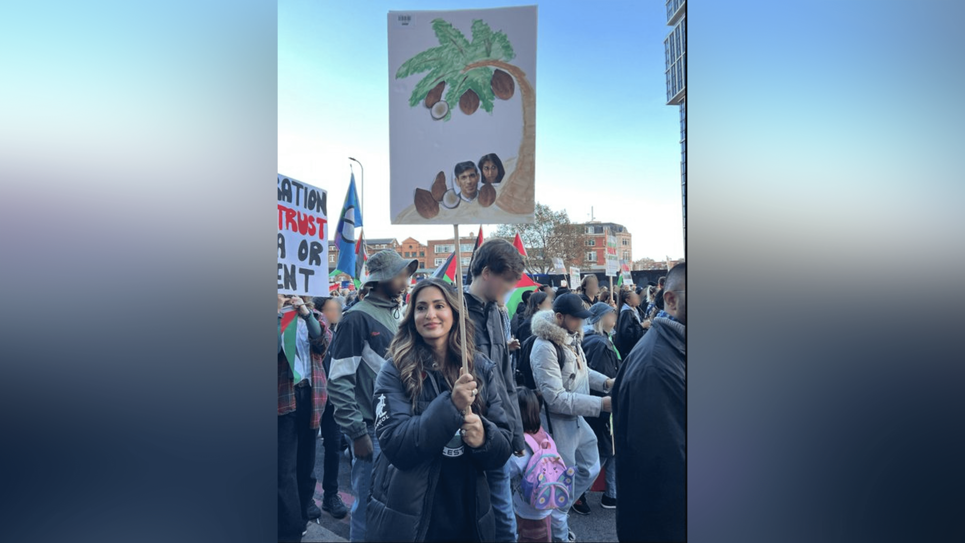 Marieha Hussain carrying a placard