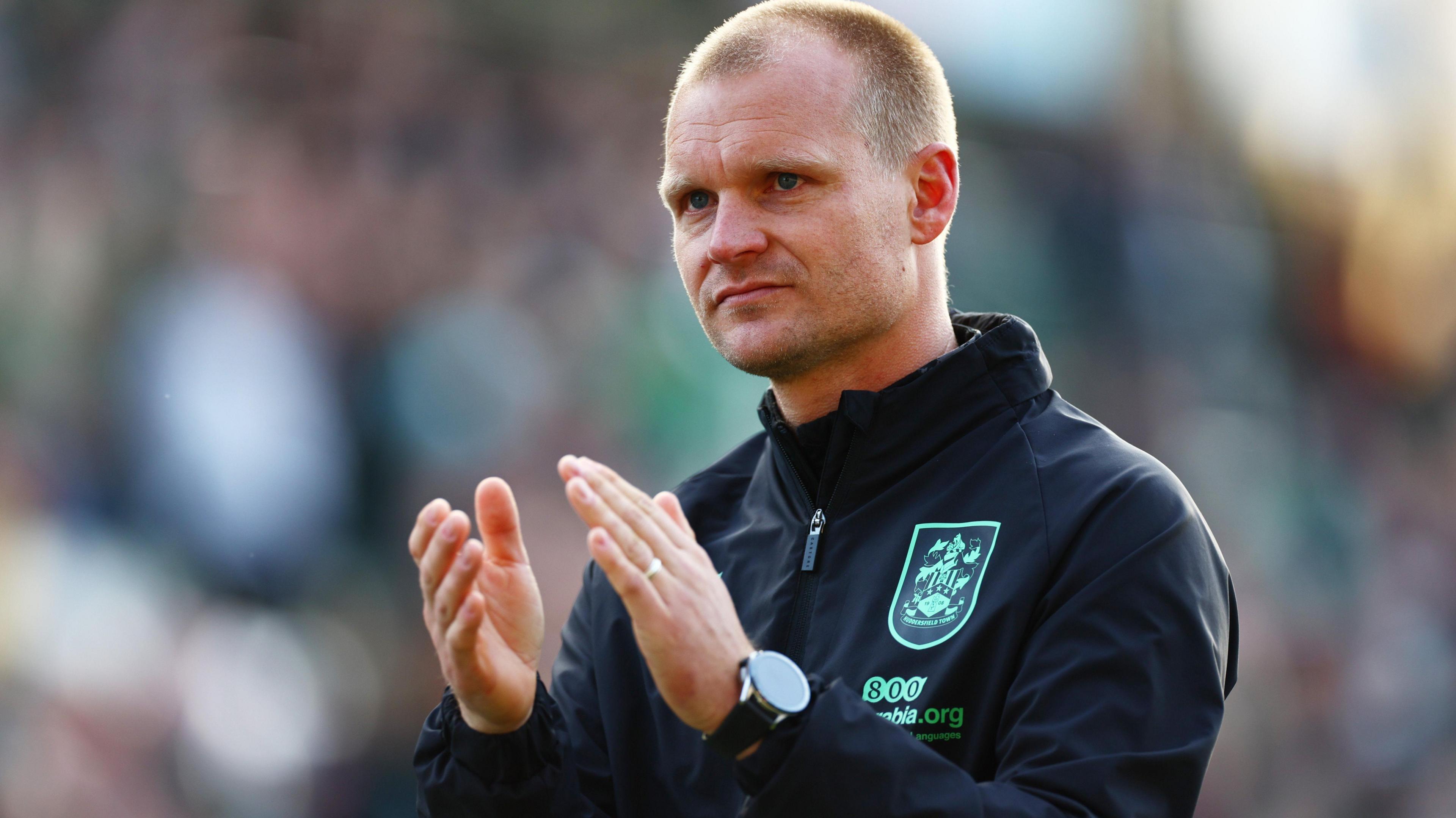 Huddersfield Town boss Liam Manning claps the club's fans after a 3-1 defeat at Plymouth in League One