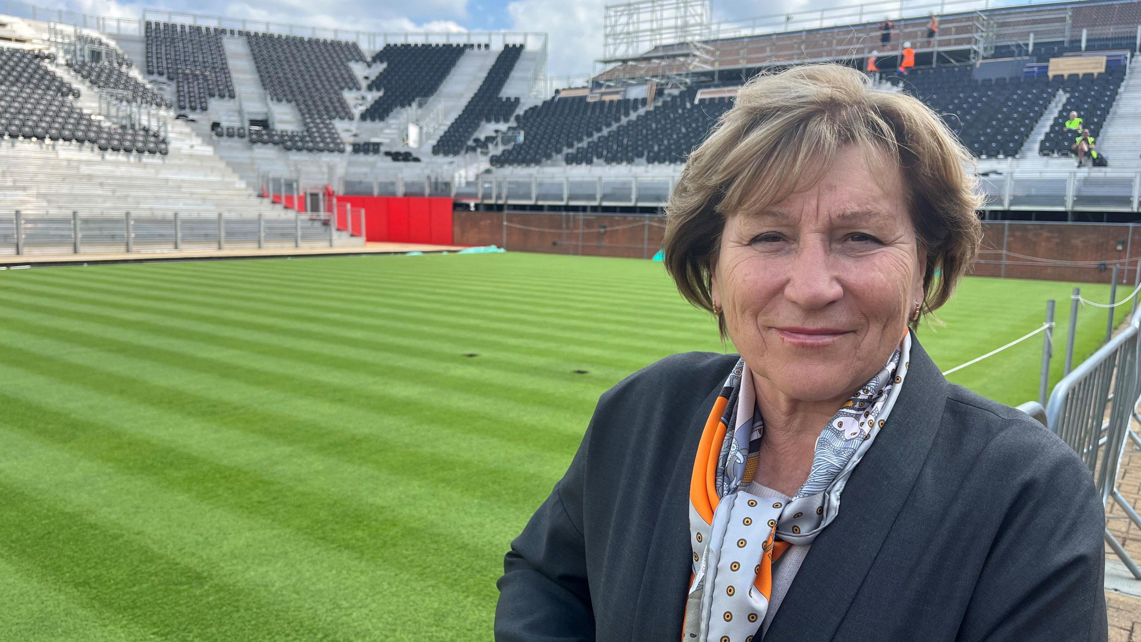 Olga Morozova stands next a court at Queen's