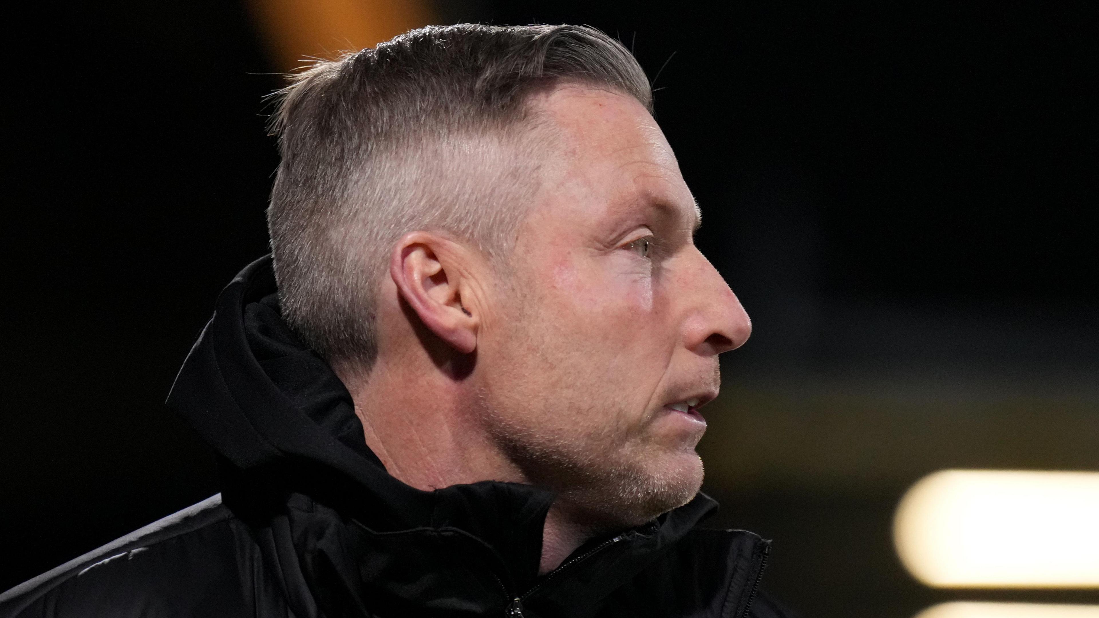 A side-on shot of Neil Harris as he watches Cambridge play