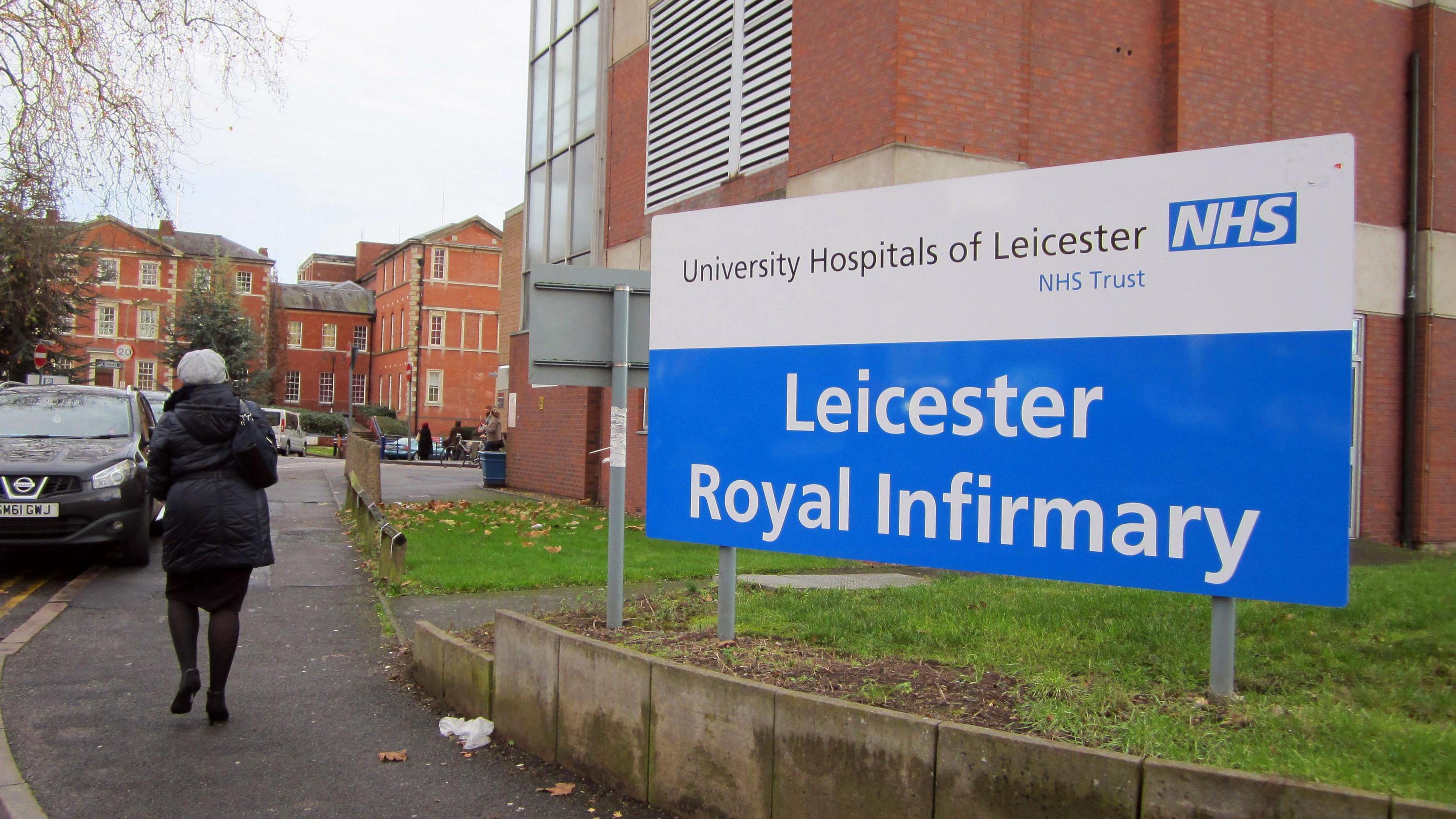 Exterior shot of the Leicester Royal Infirmary with a woman walking past