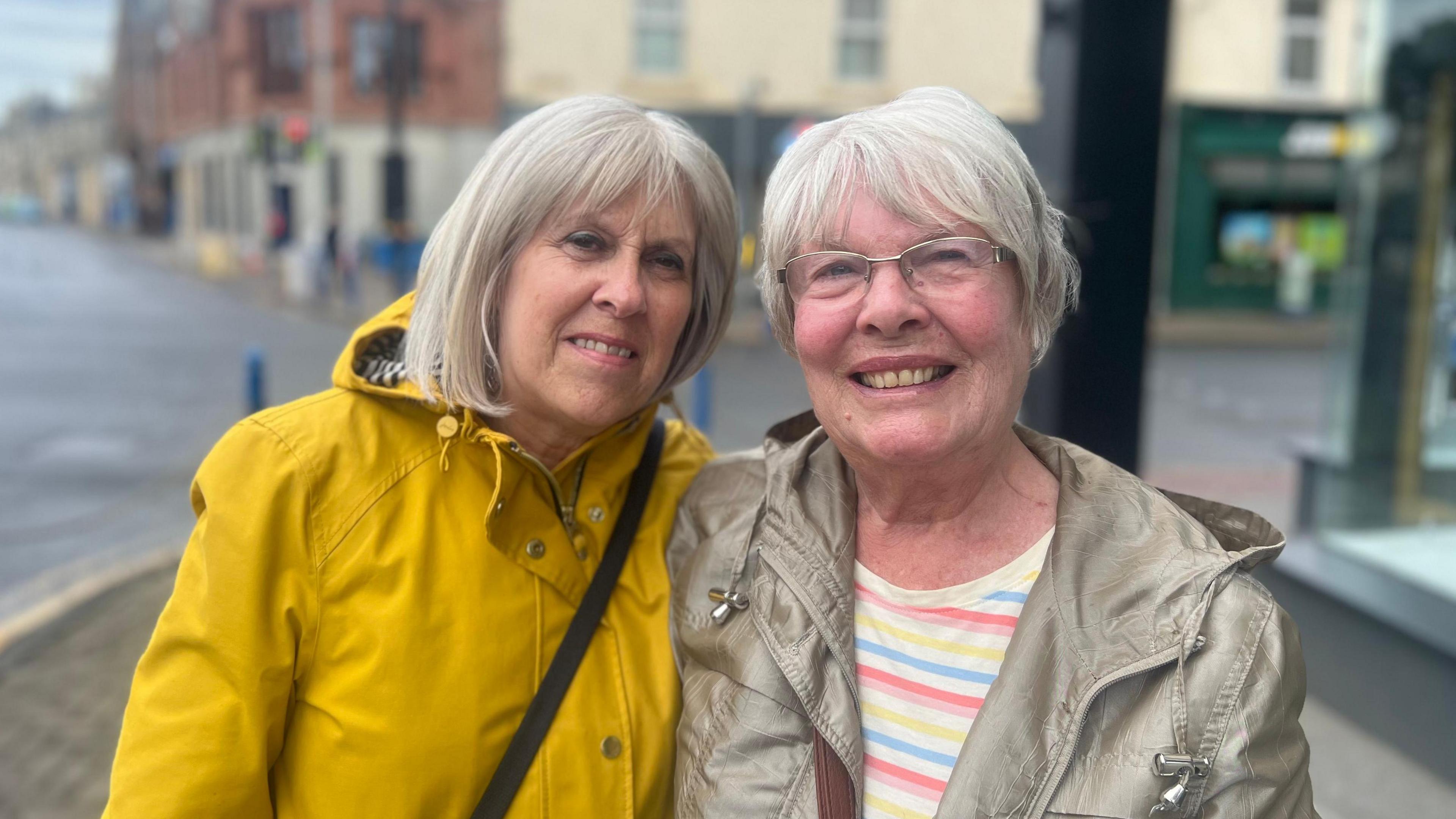 Two women stood beside each other smiling