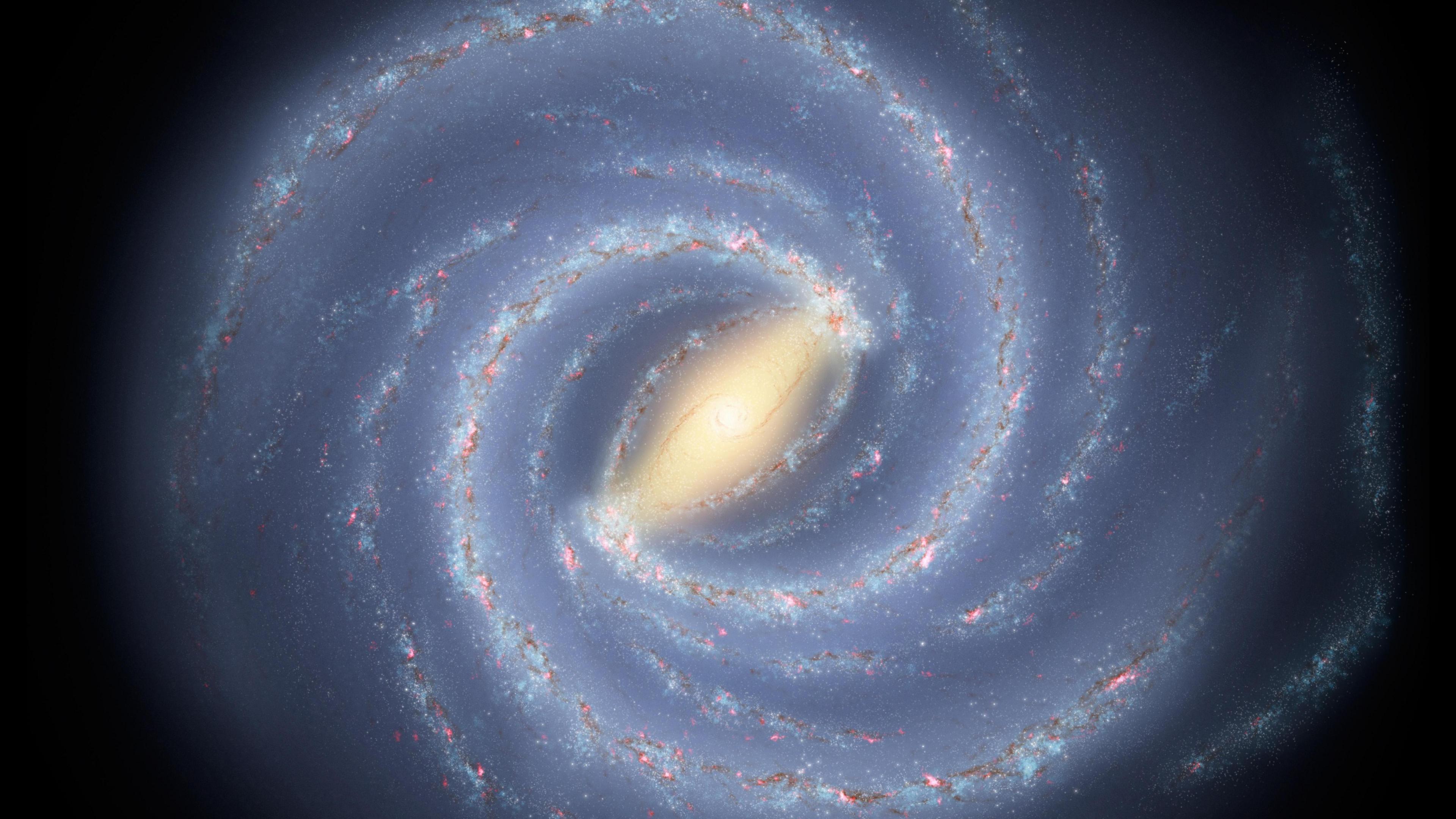 An artist’s concept of the Milky Way galaxy. A bright yellow halo is surrounded by a sparkling white spiral. 