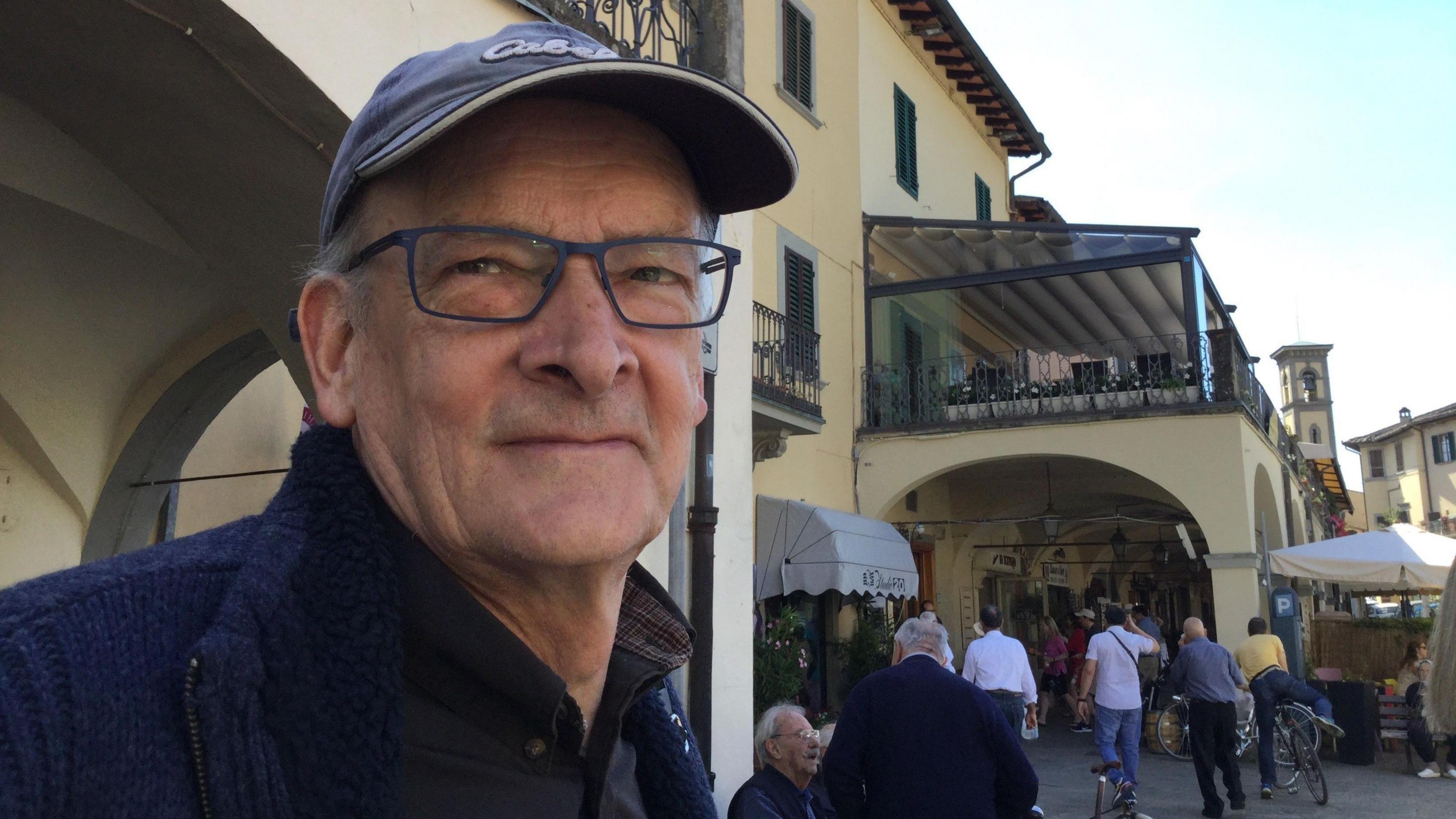 Dave is pictured on one of his holidays since retiring. He's in a busy market place.