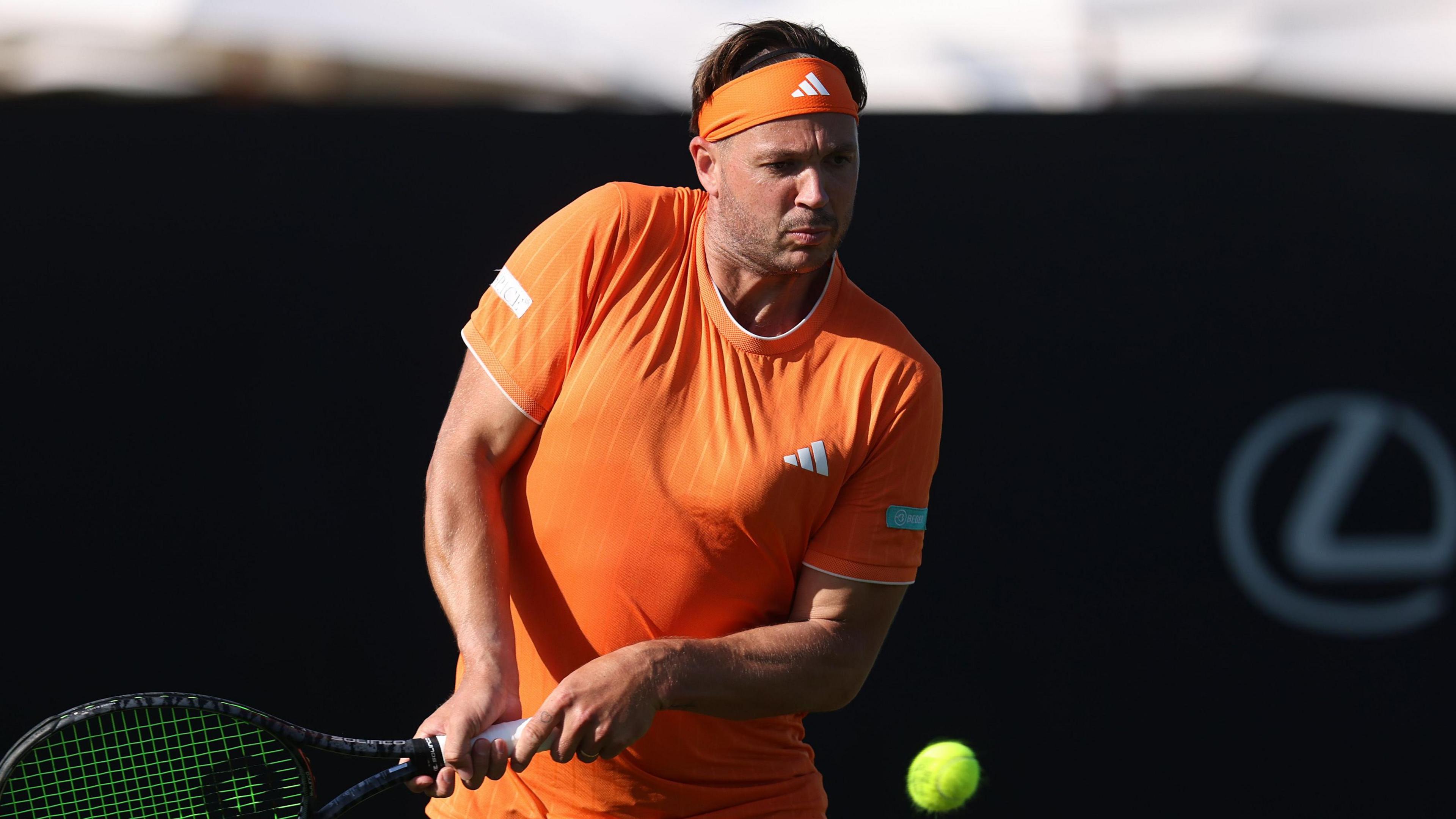 Marcus Willis hits a return