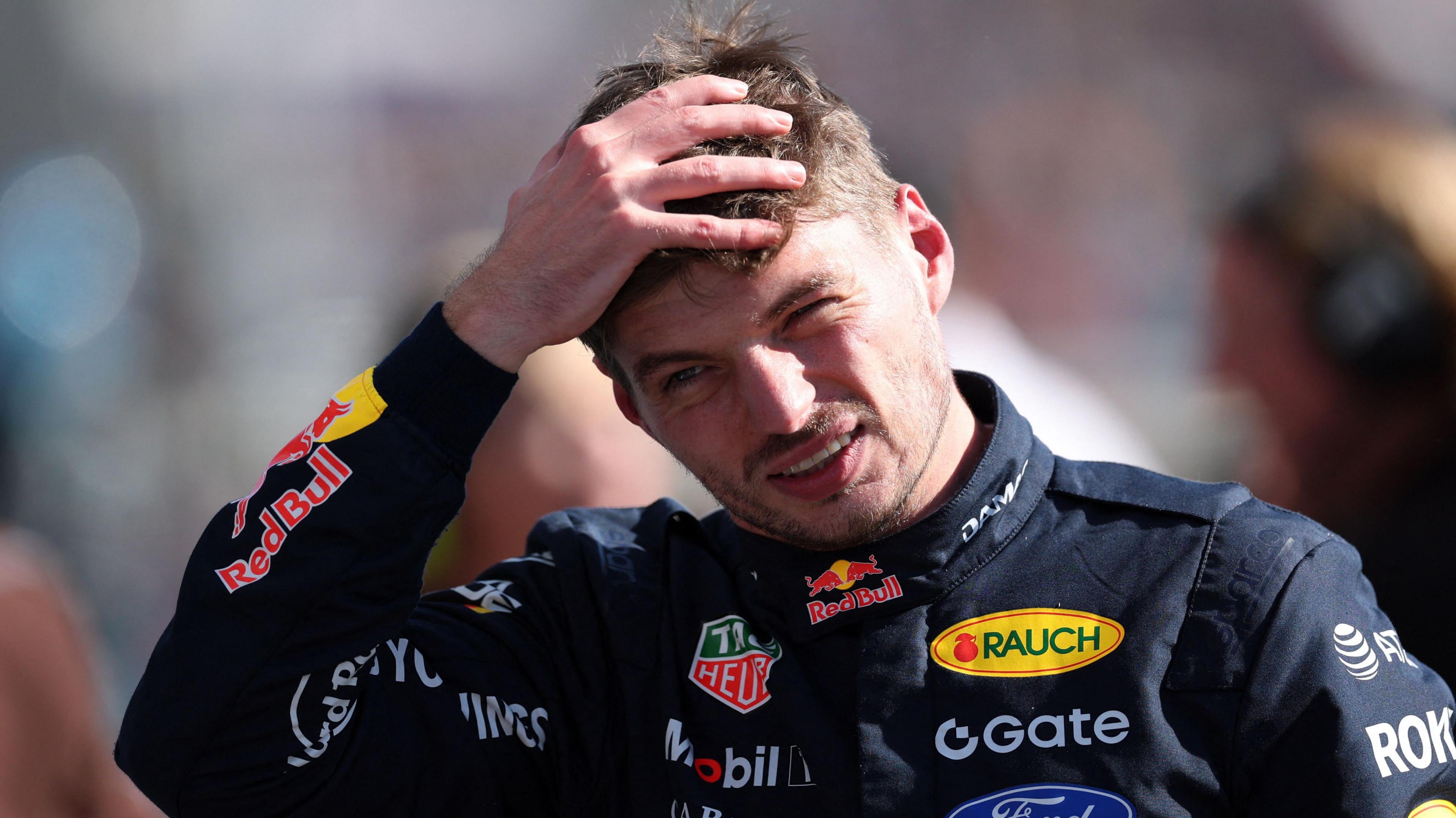 Red Bull's Max Verstappen runs his hands through his hair 