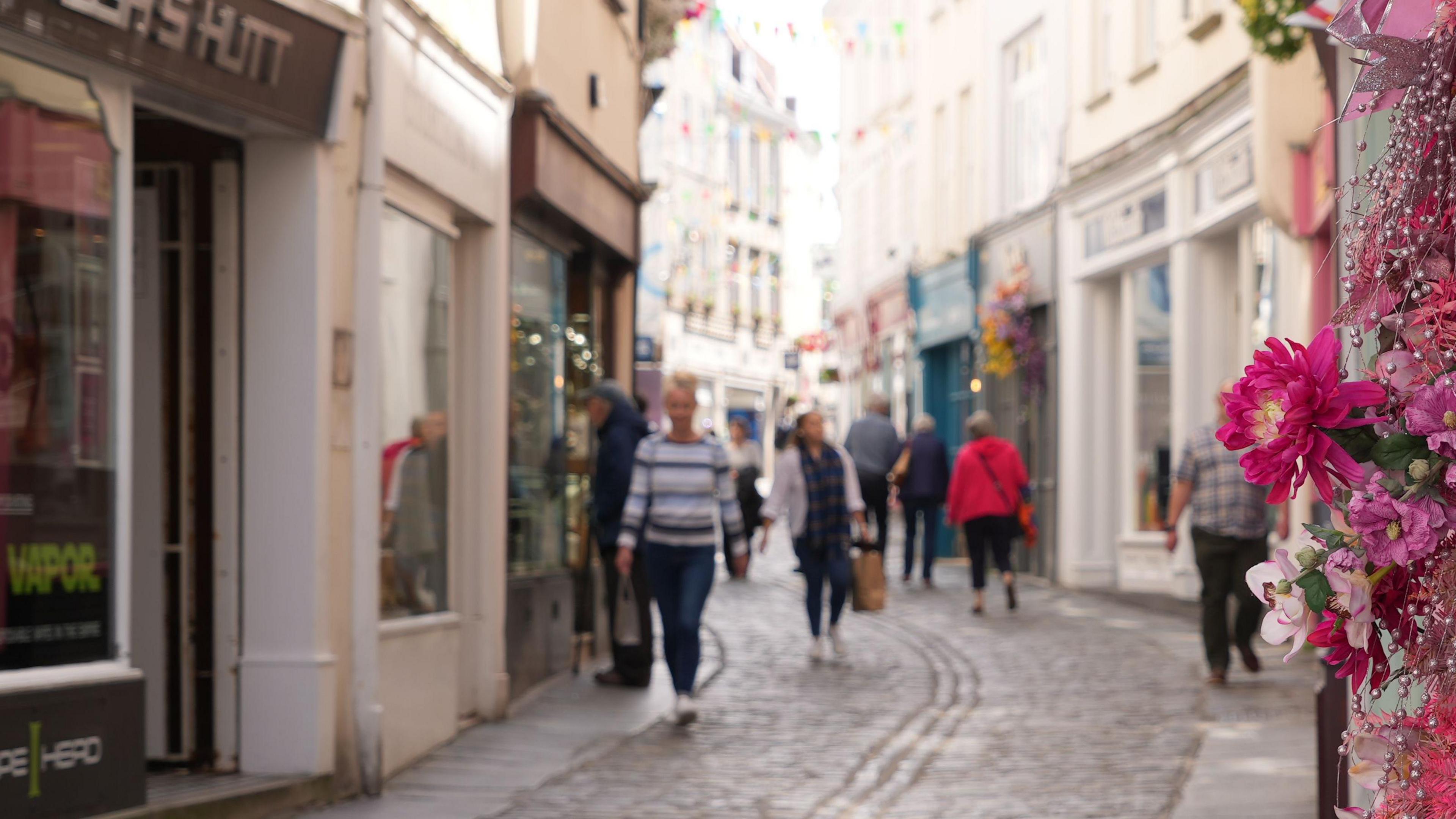 People walking down the Pollet in St Peter Port, Guernsey