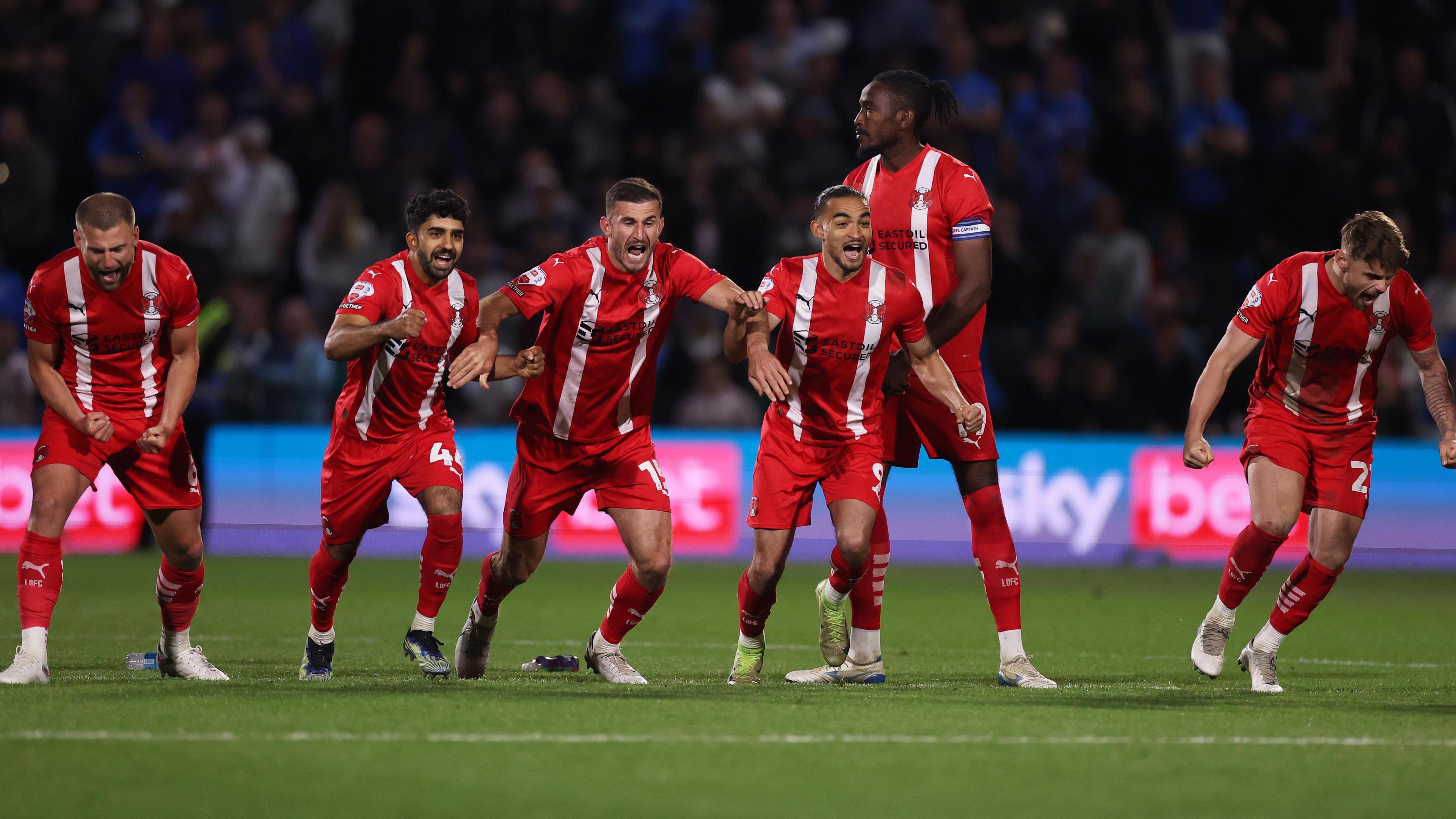 Leyton Orient players celebrate winning on penalties against Stockport