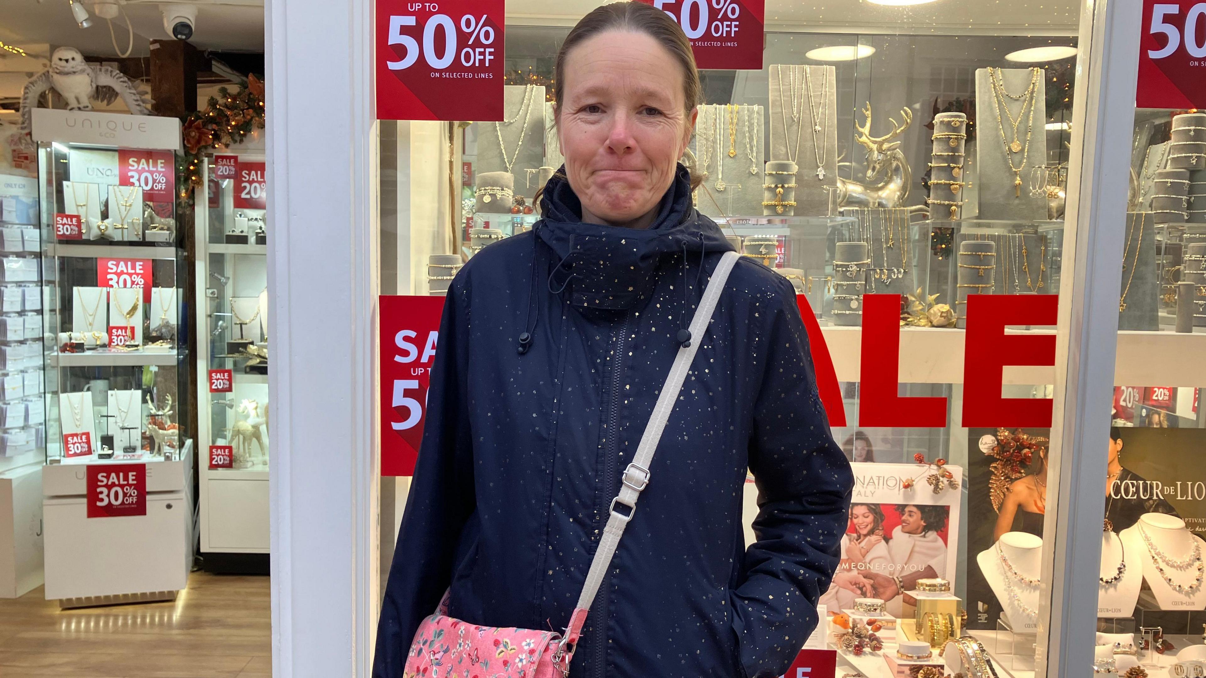 A woman outside a jewellery store on Braintree High Street