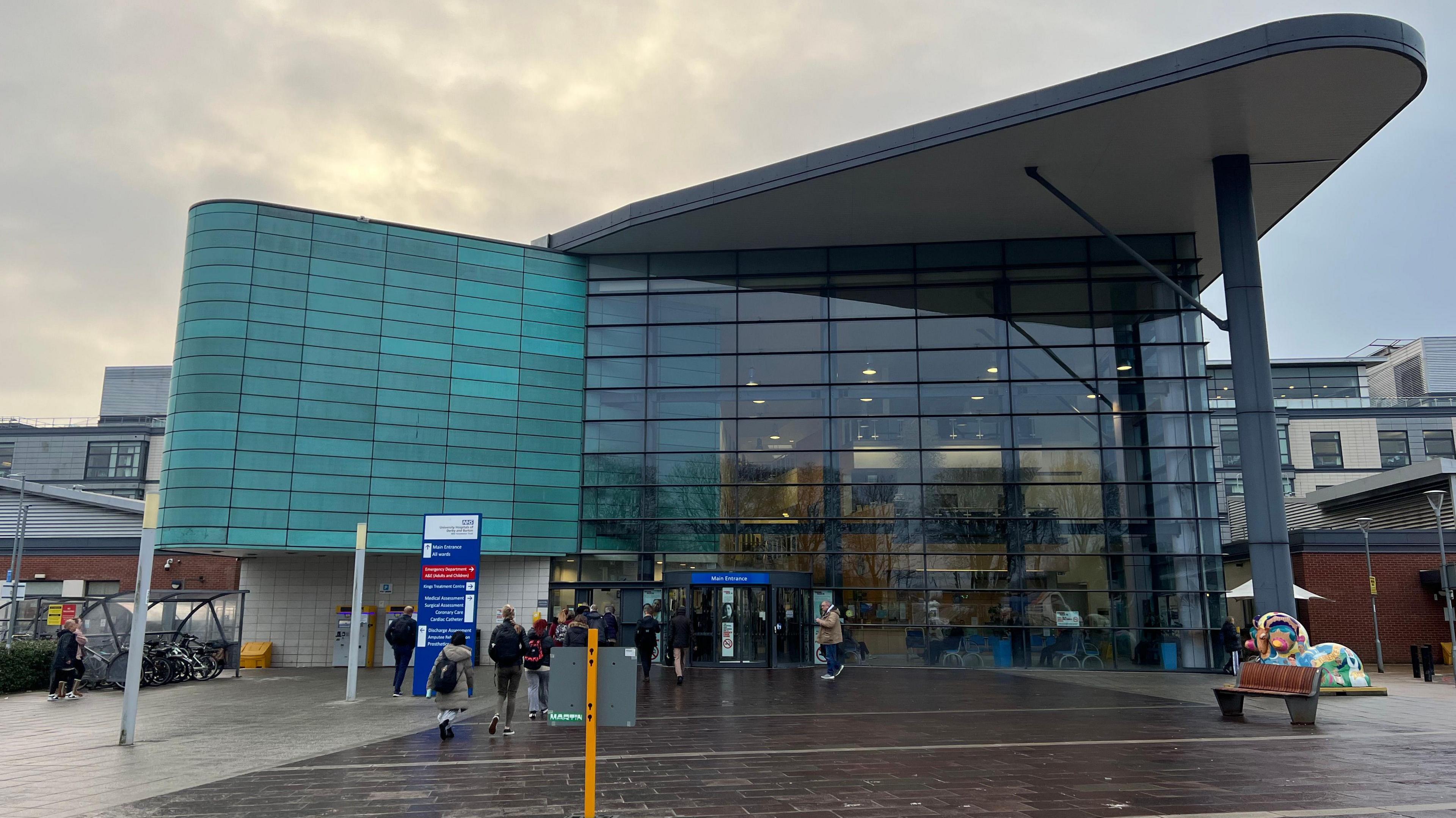 Main entrance of a modern hospital building with glass windows 