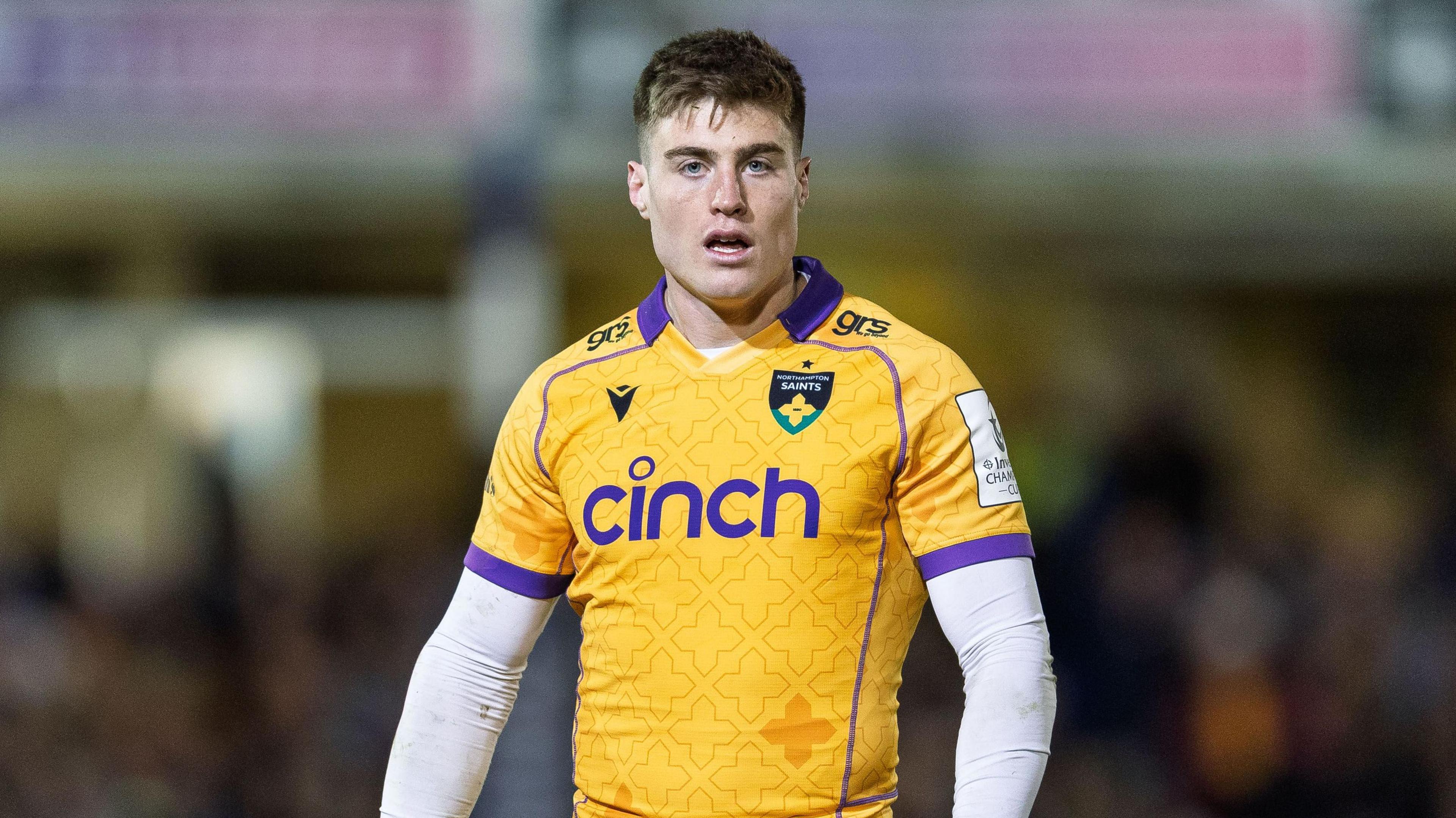 Tommy Freeman standing on the pitch with his arms by his sides during a game for Northampton Saints