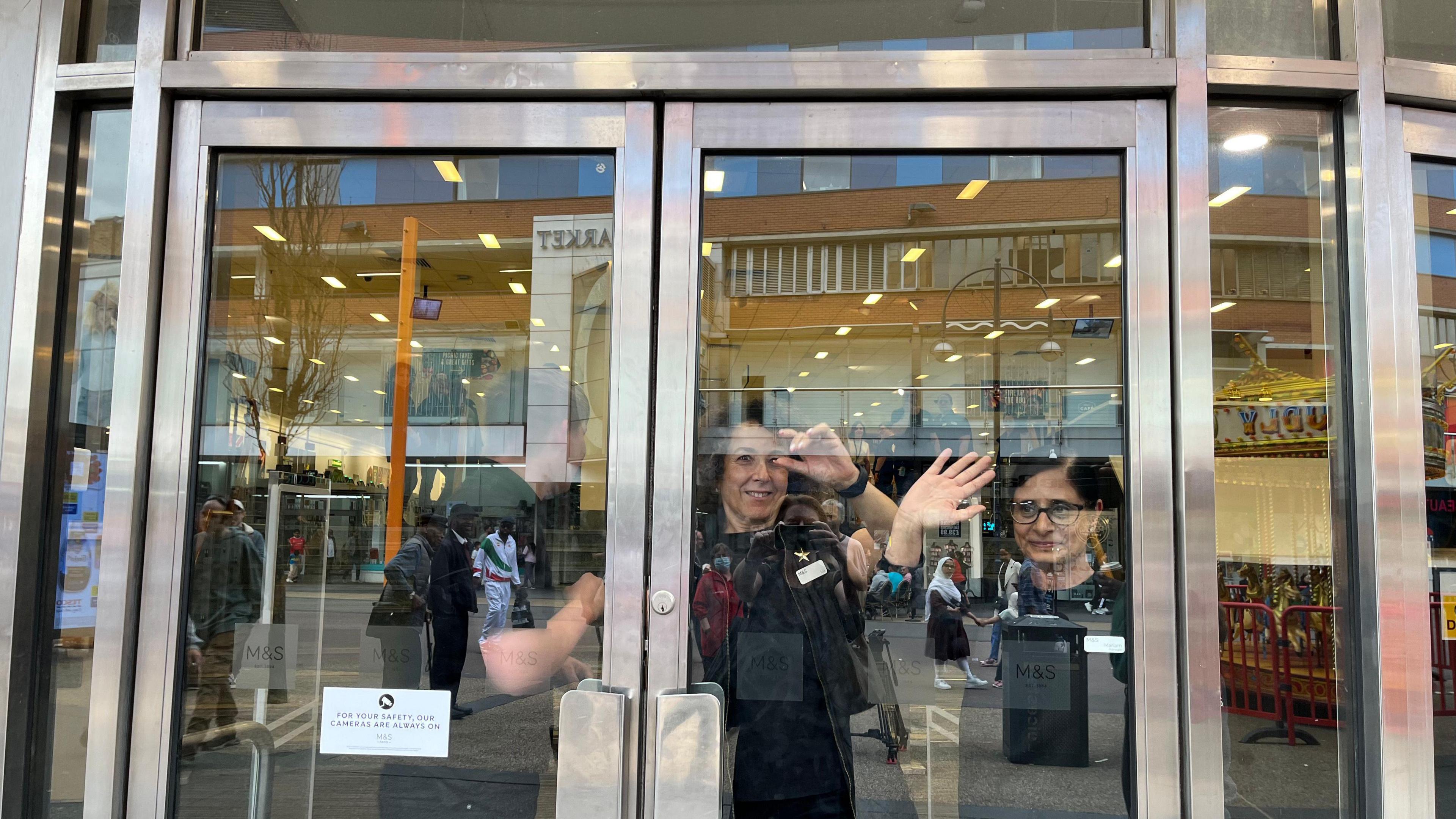 Staff waving to shoppers in Leicester