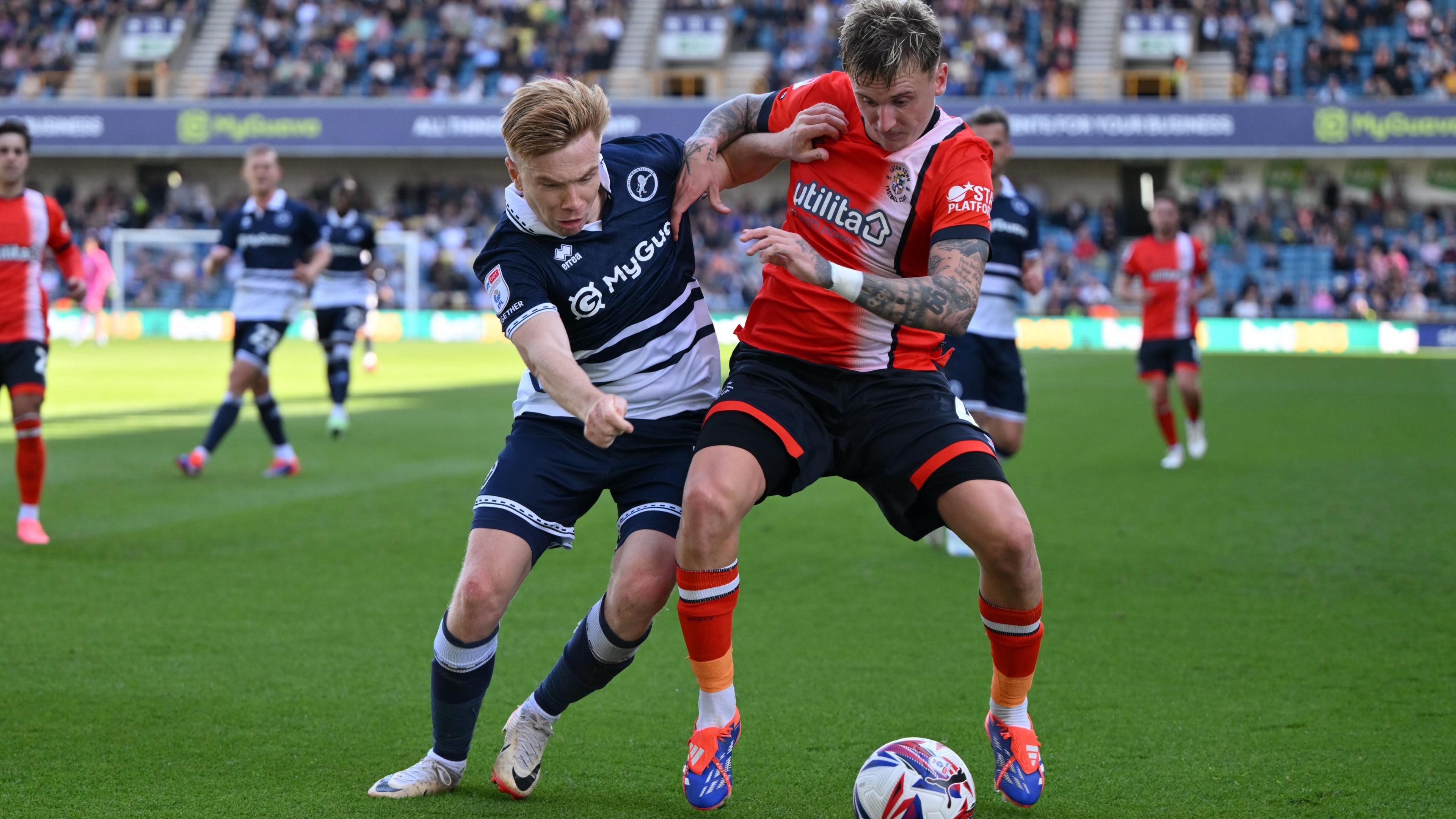 Millwall's Duncan Watmore under pressure from Luton Town's Alfie Doughty